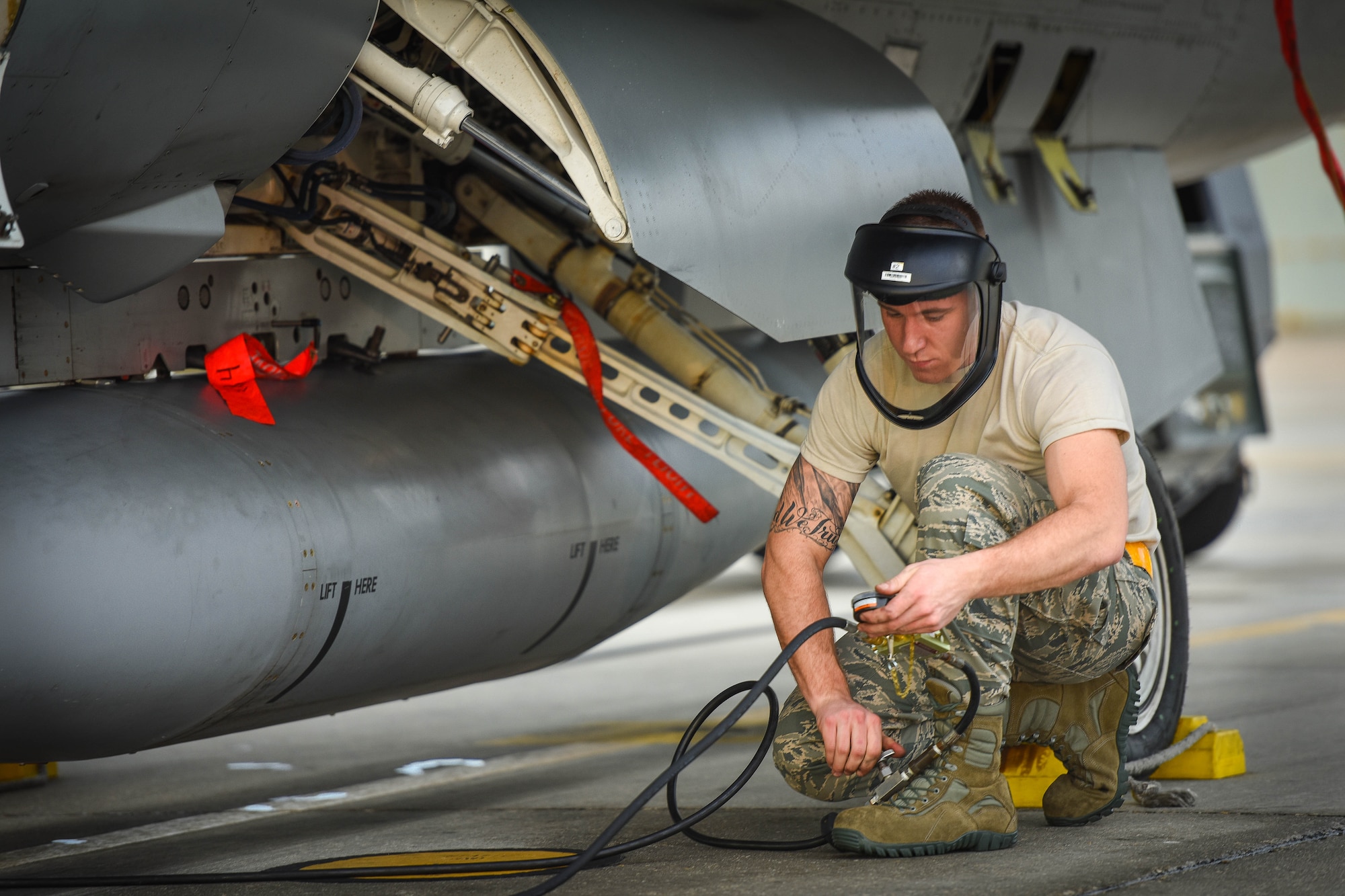 Senior Airman Josh Miller, a crew chief with the 180th Fighter Wing, inflates tires of an F-16C on the flight line of Naval Station Key West, Boca Chica Island, Florida, Jan.12, 2015. The 180th Fighter Wing deployed to Key West, Florida to conduct dissimilar aircraft training with F-5’s from the Naval Station Key West and F-15’s from the 159th Fighter Wing, from New Orleans, Louisiana. (Air National Guard photo by Staff Sgt. Amber Williams/Released)