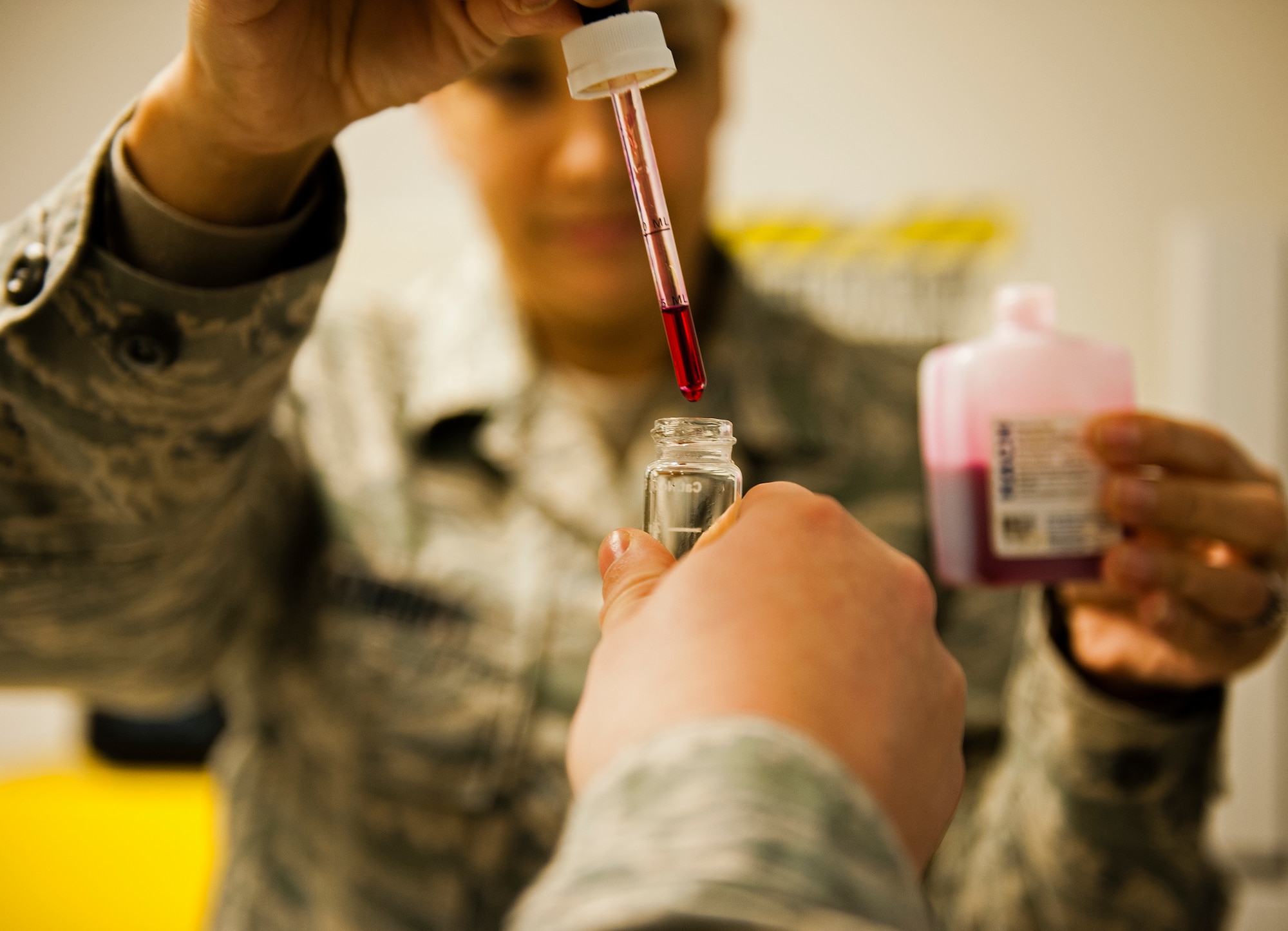 Tech. Sgt. Ninfa McKnight, 65th Medical Group bioenvironmental non-commissioned officer in charge, drops a solution into a vial of water to test the pH balance on Lajes Field, Azores, Portugal, Jan. 22, 2015. The 65th MDG recently renewed their accreditation through the Accreditation Association for Ambulatory Health Care, Inc. (U.S. Air Force photo/Staff Sgt. Zachary Wolf)