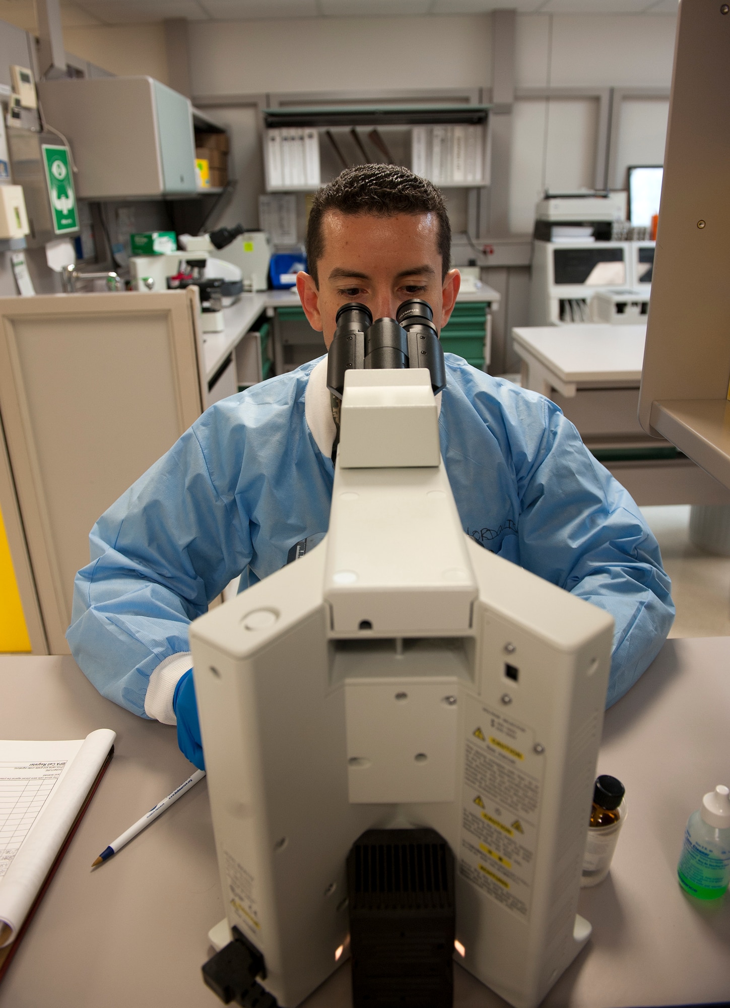 Tech. Sgt. Daniel Roman, 65th Medical Group medical laboratory technician, looks into a microscope at the lab on Lajes Field, Azores, Portugal, Jan. 22, 2015. The lab recently passed an inspection by the College of American Pathologists. (U.S. Air Force photo/Staff Sgt. Zachary Wolf)