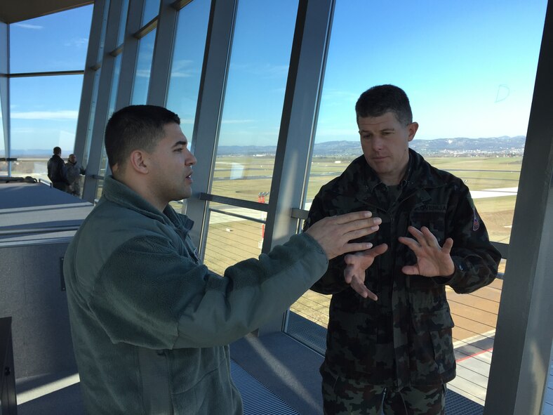 U.S. Air Force Senior Master Sgt. Bobby Hickman (left), 31st Operational Support Squadron chief controller, and Slovenian Air Force Maj. Gregor Hribar, 15th Wing airfield manager, discuss the capabilities of the air traffic control tower systems during a mission, at Cerklje Air Base, Slovenia, Jan. 13, 2015. The five-day mission supported U. S. Air Forces in Europe Air Forces Africa’s efforts to assist the Slovenian Air Force in developing control measures for take-off and landing procedures during instrument flight rules conditions, giving the base the capability to conduct flights is inclement weather conditions. (U.S. Air Force photo/Major John C. Sherinian)