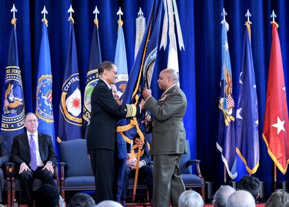 U.S. Marine Corps Lt. Gen. Vincent R. Stewart (right) accepts the Joint Functional Component Command for Intelligence, Surveillance and Reconnaissance flag, as a symbol of command, from U.S. Navy Adm. Cecil D. Haney, U.S. Strategic Command commander. Stewart assumed command during a ceremony at Defense Intelligence Agency headquarters, Joint Base Anacostia-Bolling, Washington, D.C., Jan. 23, 2015. As JFCC-ISR commander, Stewart, who oversees an organization directed by USSTRATCOM, recommends allocation of ISR capabilities to satisfy strategic and high-priority combatant command and national operational and intelligence requirements; advocates for ISR capabilities; and provides functional support for USSTRATCOM's other global strategic missions. (Photo courtesy of DIA Public Affairs)