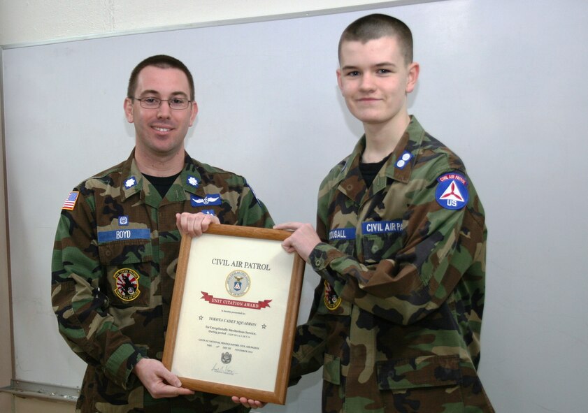 Civil Air Patrol Lt. Col. Adam Boyd, Yokota Cadet Squadron commander, presents the Unit Citation Award to Squadron Cadet Commander Cadet 1st Lt. Michael McDougall at Yokota Air Base, Japan on January 8, 2015. The Civil Air Patrol Unit Citation Award is presented for exceptionally meritorious service or exceptionally outstanding achievement. (Civil Air Patrol photo by 2nd Lt. Billie Thompson/released)