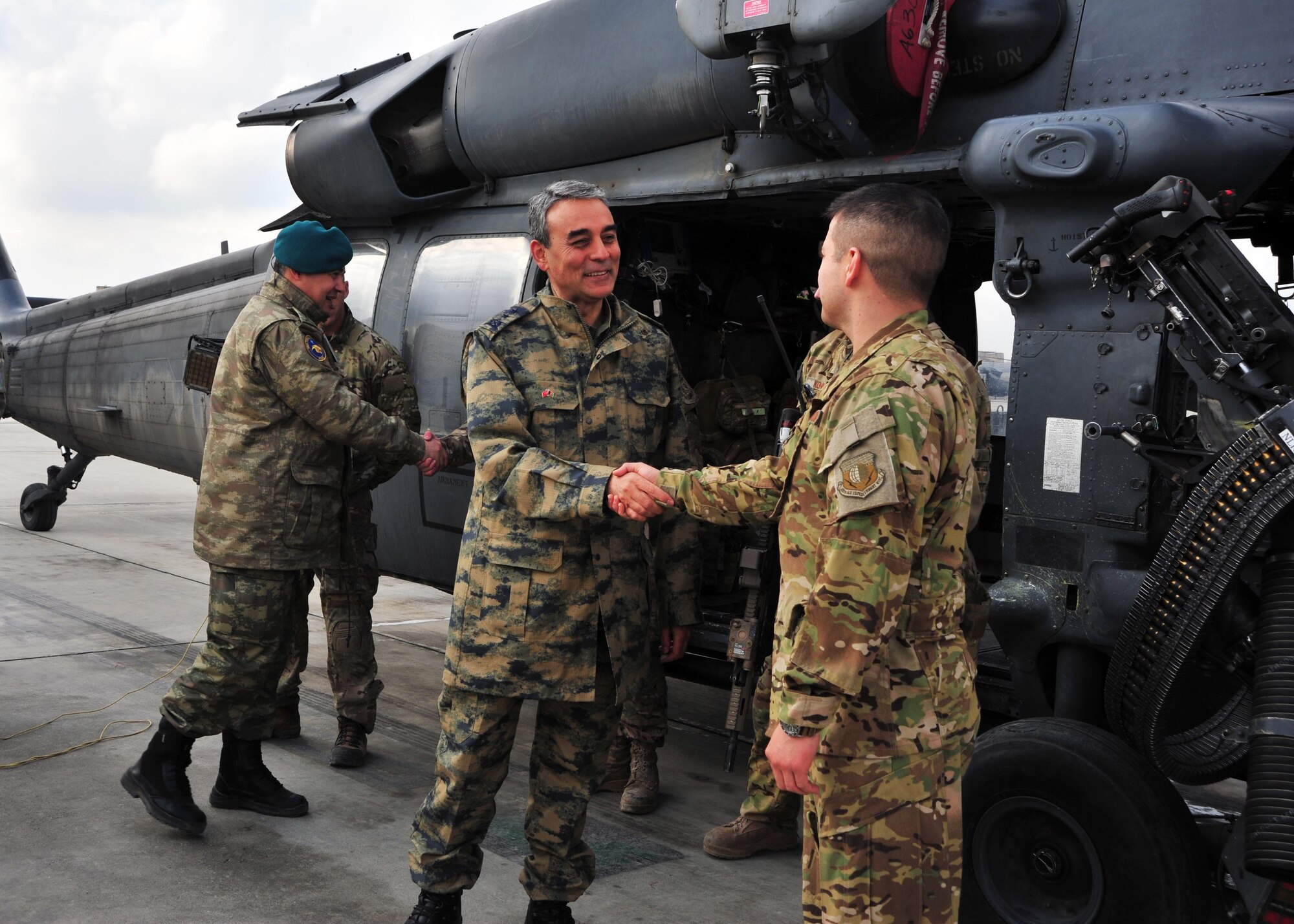 Turkish Air Force Maj. Gen.  Mehmet Cahit Bakir, Commander of Kabul International Airport, shakes hands with U.S. Air Force Capt. Mark Morales, 83rd Expeditionary Rescue Squadron, during a tour Jan. 22, 2015 at Bagram Airfield, Afghanistan. During the tour, Bakir had the opportunity to meet with 455th Air Expeditionary Wing leadership and become better acquainted with Air Force assets and squadrons here. (U.S. Air Force photo by Staff Sgt. Whitney Amstutz/released)