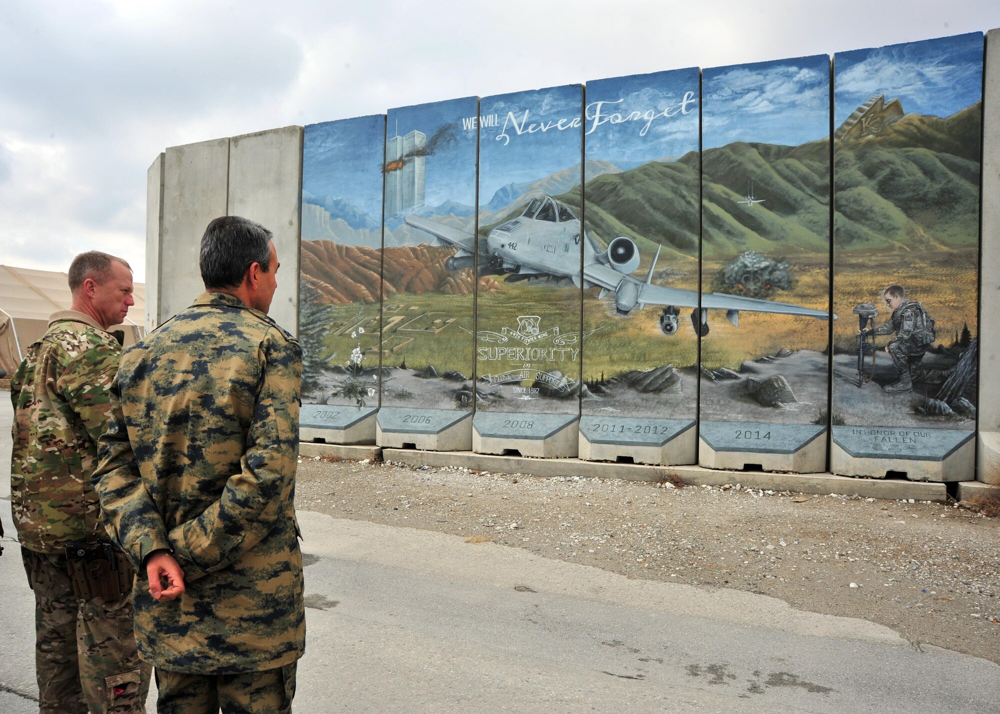 U.S. Air Force Brig. Gen. Mark Kelly, 455th Air Expeditionary Wing commander, and Air Force Maj. Gen.  Mehmet Cahit Bakir, Commander of Kabul International Airport, admire a mural during a tour Jan. 22, 2015 at Bagram Airfield, Afghanistan. During the tour, Bakir had the opportunity to meet with 455th Air Expeditionary Wing leadership and become better acquainted with Air Force assets and squadrons here. (U.S. Air Force photo by Staff Sgt. Whitney Amstutz/released)