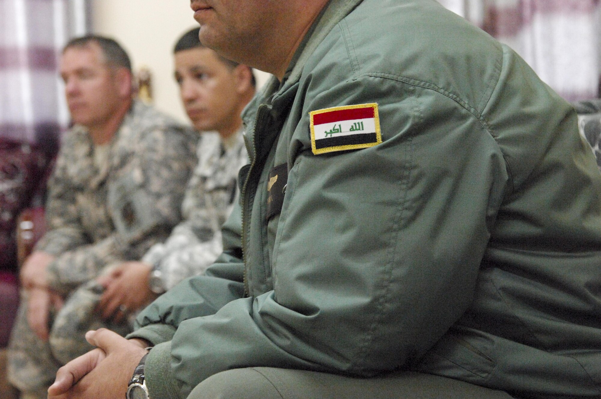 An Iraqi pilot is seen sitting with members of the 3rd Sustainment Brigade and 1st Theater Sustainment Command during a meeting in Iraq to discuss the U.S. mission to advise and assist the Iraqi air force Jan. 5, 2014. The Iraqi air force has been working with members of the 386th Air Expeditionary Wing and the U.S. Army on developing and improving the airdrop capability of the Iraqi air force. To date, the 23rd Squadron of the Iraqi air force has dropped more than 200 bundles. (U.S. Air Force photo by 1st Lt Sarah Ruckriegle/released)