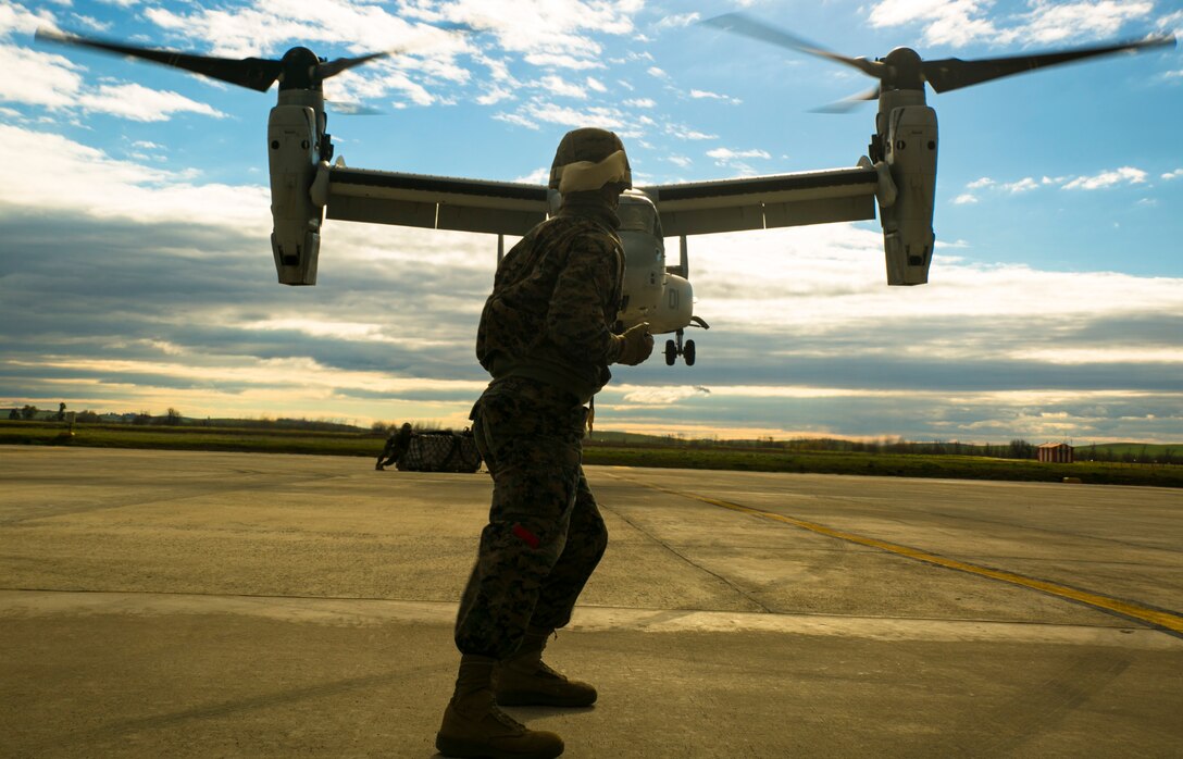 U.S. Marine Lance Cpl. Cody Keller, a landing support specialist with Special-Purpose Marine Air-Ground Task Force Crisis Response-Africa, signals an MV-22 Osprey to hover to its right during an external-lift drill at Morón Air Base, Spain, Jan. 19, 2015. Keller’s vantage point on the ground allowed him to precisely guide the aircraft, an especially important task on obstacle-riddled terrain. (U.S. Marine Corps photo by Sgt. Paul Peterson)