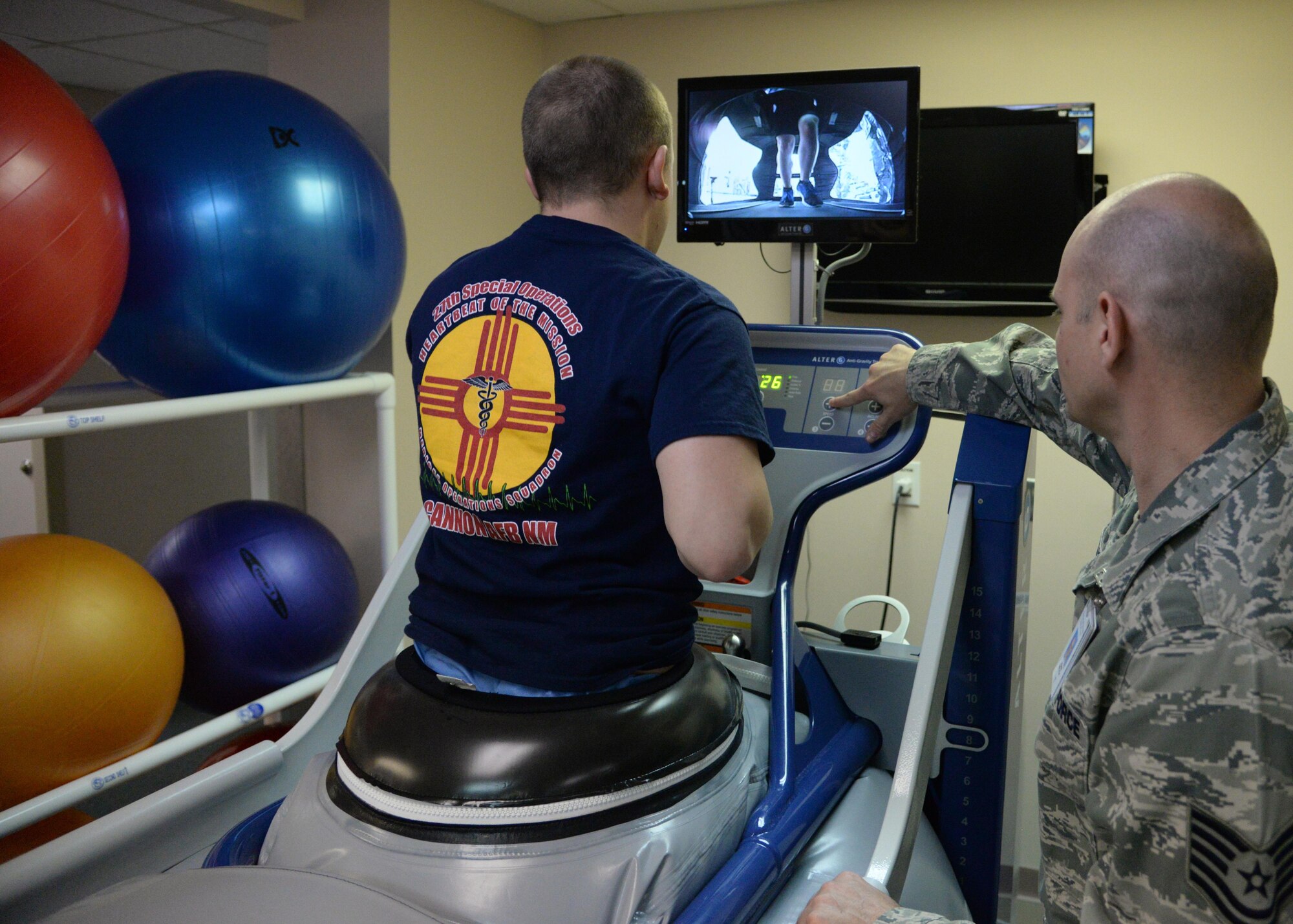 U.S. Air Force Tech. Sgt. John Welch, 27th Special Operations Medical Operations Squadron, programs an anti-gravity treadmill for a patient Jan. 21, 2015 at Cannon Air Force Base, N.M. The machine inflates to lower body weight, removing impact for patients who experience pain during normal running. (U.S. Air Force photo/Staff Sgt. Alexxis Mercer) 