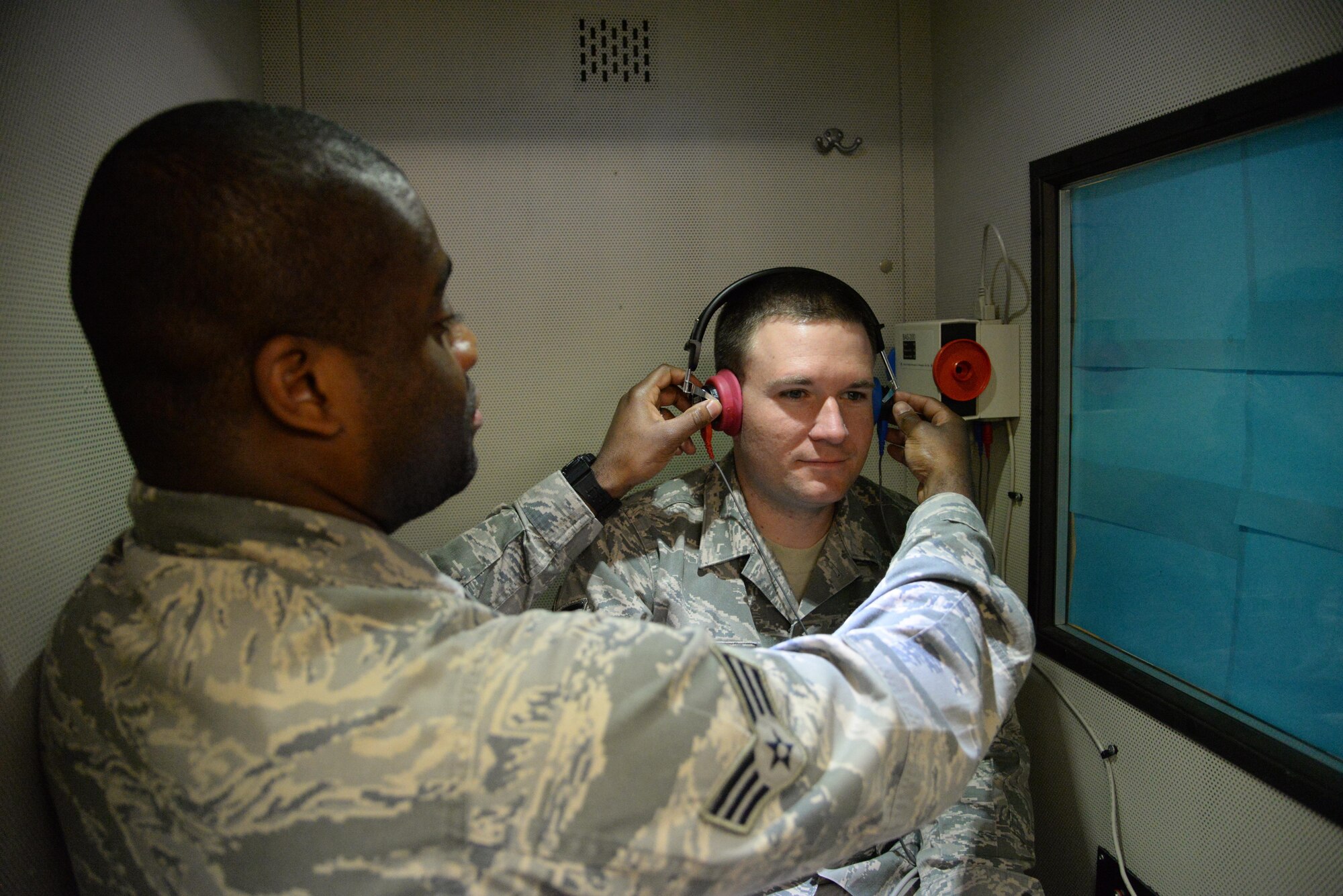 Two U.S. Air Force Airmen with 27th Special Operations Medical Group test a sound booth Jan. 21, 2015 at Cannon Air Force Base, N.M. This asset is manned by the public health flight of the Cannon clinic. (U.S. Air Force photo/Staff Sgt. Alexxis Mercer) 
