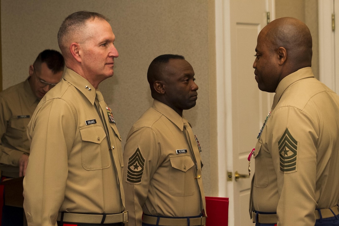 Sergeant Maj. Michael A. Logan receives his certificate of retirement during a ceremony at the Clubs of Quantico on Jan. 23, after serving on active duty for more than 30 years. Sergeant Maj. Logan was replaced by Sgt. Maj. Samuel Heyward Jr. as the Sergeant Major of Marine Corps Recruiting Command.
