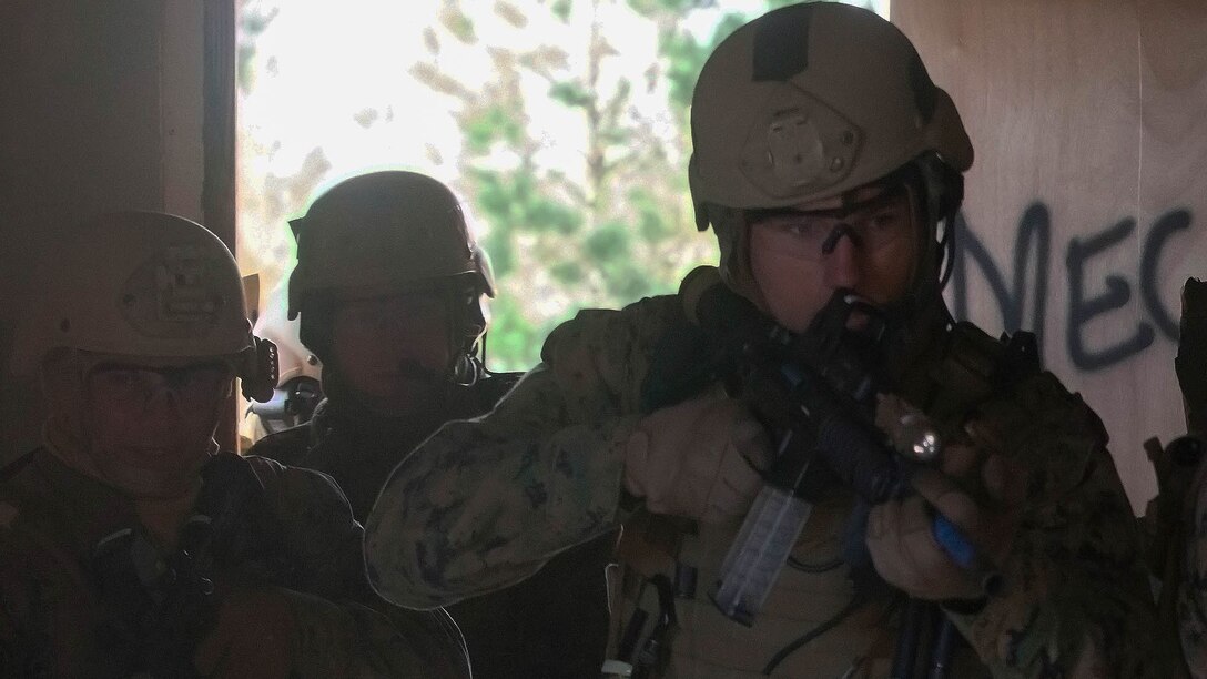 Marines with Force Company, 2nd Reconnaissance Battalion, 2nd Marine Division clear a room after conducting a mechanical breach during a breach and clear exercise aboard Camp Lejeune, N.C., Jan. 15, 2015. Marines with Force Company conducted explosive and mechanical breaches and limited force raids in preparation for future deployments. 