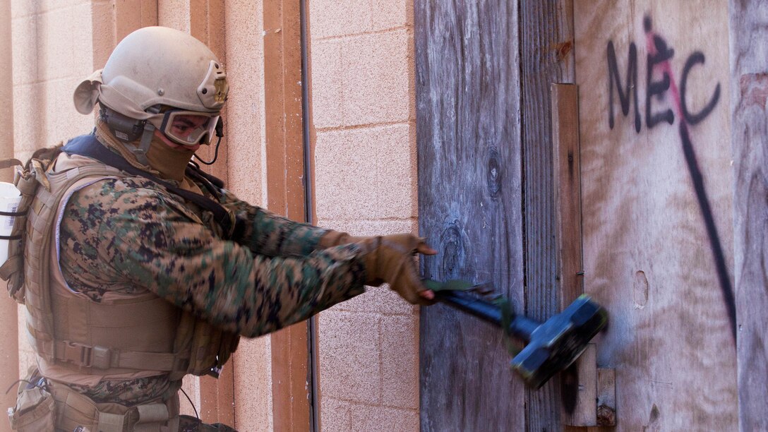 A Marine with Force Company, 2nd Reconnaissance Battalion, 2nd Marine Division, use a sledgehammer to mechanically breach a door during a breach and clear exercise aboard Camp Lejeune, N.C., Jan. 15, 2015. Marines with Force Company conducted explosive and mechanical breaches and limited force raids in preparation for future deployments. 
