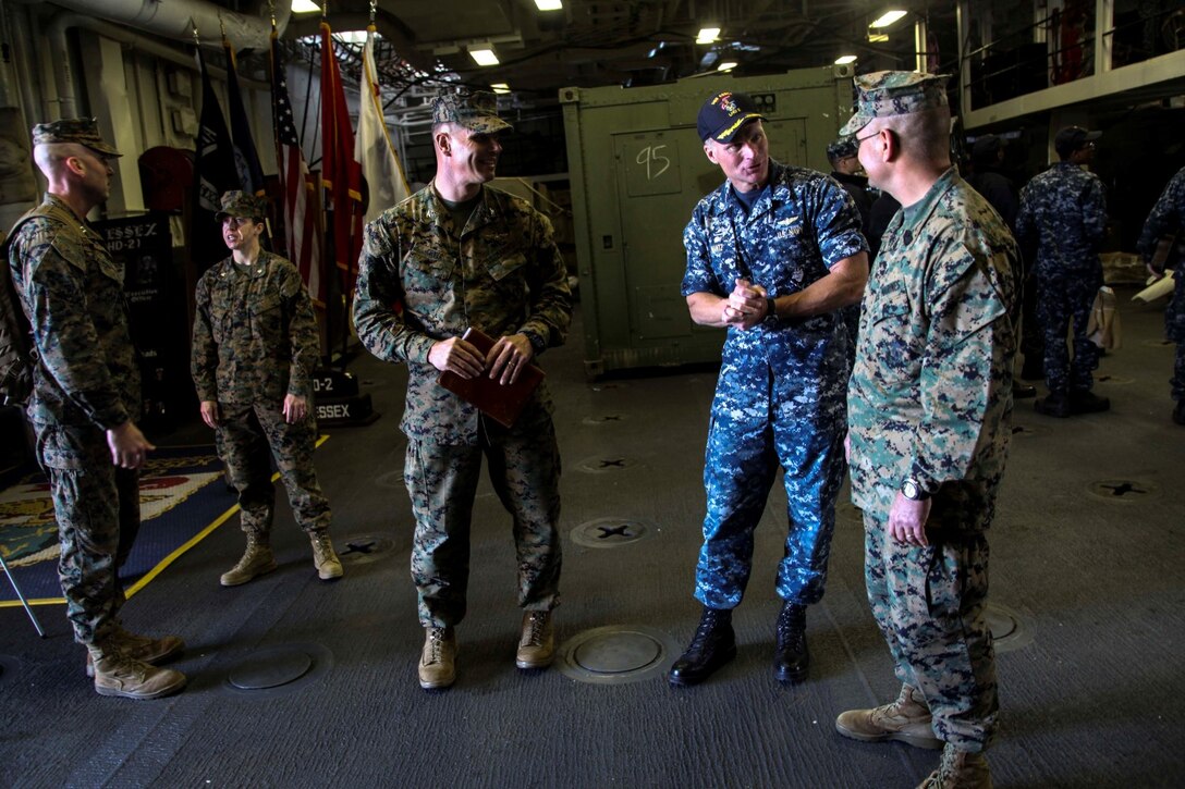 U.S. Marine Col. Vance L. Cryer, left, speaks with Navy Capt. Peter M. Mantz and Sgt. Maj. Douglas B. Schaefer aboard USS Essex (LHD 2) at Naval Base San Diego Jan. 24, 2014. Mantz is the commanding officer of the USS Essex. Cryer is the commanding officer of the 15th Marine Expeditionary Unit. Schaefer is the sergeant major of the 15th MEU. USS Essex is part of the Essex Amphibious Ready Group which is scheduled to deploy with the 15th MEU this spring. (U.S. Marine Corps photo by Cpl. Elize McKelvey/Released)