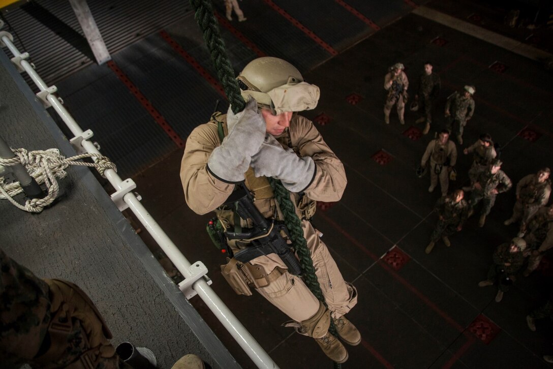 U.S. Marines with the 15th Marine Expeditionary Unit's Maritime Raid Force practice fast-roping procedures in the well deck of USS Essex (LHD 2) at Naval Base San Diego Jan. 24, 2015. The 15th MEU was embarked aboard the three ships of the Essex Amphibious Ready Group - the USS Essex, USS Anchorage (LPD 23), and USS Rushmore (LSD 47) – to familiarize themselves with the ships as they continue to prepare for their upcoming deployment this spring.  (U.S. Marine Corps photo by Cpl. Elize McKelvey/Released)
