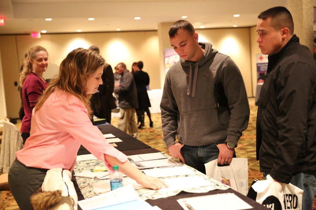 Sgt. William Turner (center), a team leader, and Staff Sgt. Sergio Rosas (right), company staff non-commissioned officer in charge of Personnel Retrieval and Processing Company (-), 4th Marine Logistics Group, speak to Christine Doboszenski, personal financial advisor with Zeiders Enterprises at the Yellow Ribbon Re-Integration Program Post-deployment training conference, Jan. 24-25, 2015 in Washington, D.C. After being deployed to Camp Bastion and Kandahar, Afghanistan, the unit attended the training as a required follow-up to their return to the continental United States. The training featured resources from the Department of Veterans Affairs, the American Red Cross, Employer Support of the Guard and Reserve, Marine For Life, and other organizations which offer financial, medical and employment advice. 