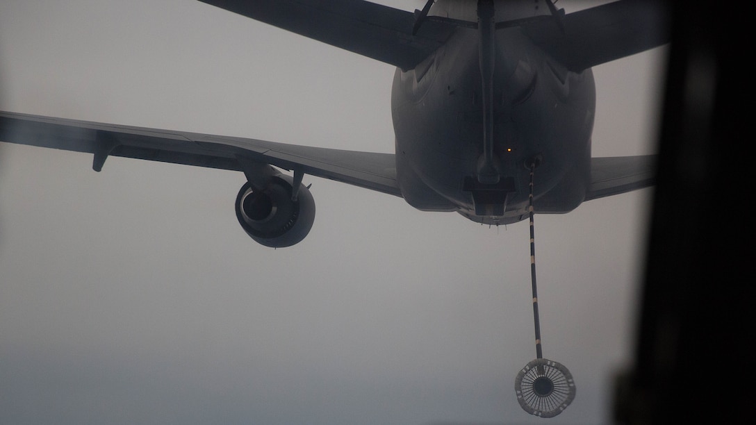 An Air Force KC-10 Extender releases its drogue, or hose, in order to refuel a MV-22B Osprey above the Marine Corps Air Station New River area, Jan. 15, 2015. Marine pilots with Marine Medium Tiltrotor Squadron 266 flew behind the KC-10 and practiced aerial refuels with the aircraft.