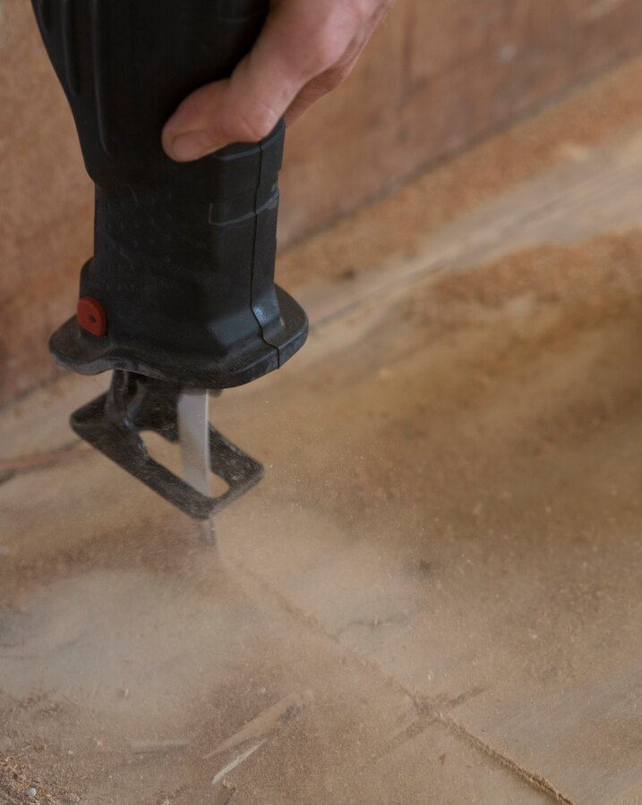 A Marine uses a buzz saw to cut out extra parts of the wooden flooring in an old military housing facility, Jan. 9, 2015 during exercise Lava Viper 15-1.2 at Kawaihae Harbor, Hawaii. The housing facility is used by various military branches as a safe house while waiting for ships to arrive with vehicles and supplies. Combat engineers with Marine Wing Support Squadron-472, Marine Aircraft Group 49, 4th Marine Air Wing has been tasked to refurbish the facility because the building is deteriorating. 