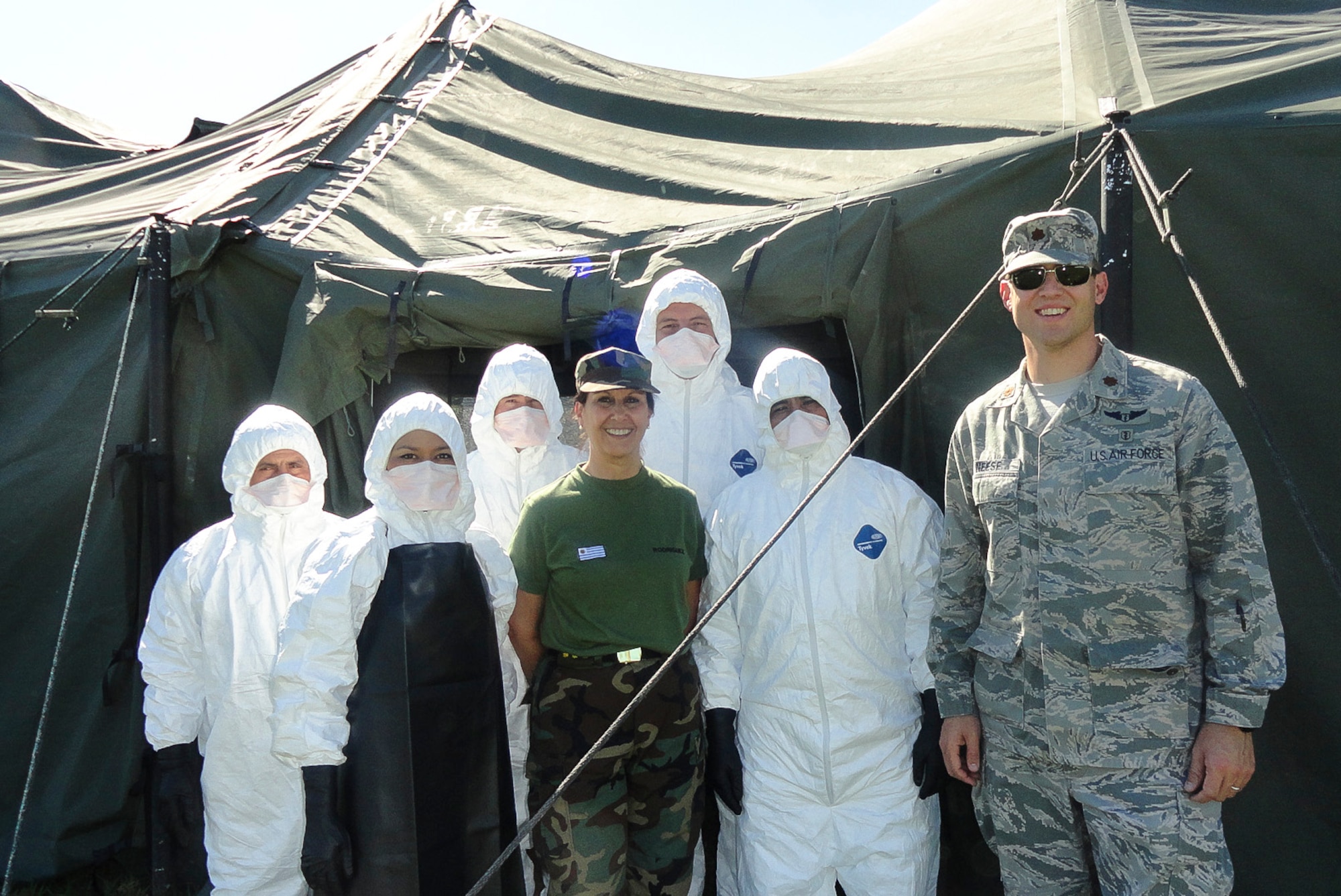 Maj. Brian Neese smiles with members after their successful completion of a final capstone exercise, aimed at testing their knowledge and ability to adapt in a timely manner to the Ebola virus on Dec. 06, 2014, in El Salvador. There are many Latin American countries that support United Nations peace keeping operations, and the training given to the El Salvadorans, Guatemalans, and Uruguayans will have an impact on those they train, as well as the individuals their able to assist. Neese is the 12th Air Force (Air Forces Southern) chief of international health specialists division. (Courtesy Photo)