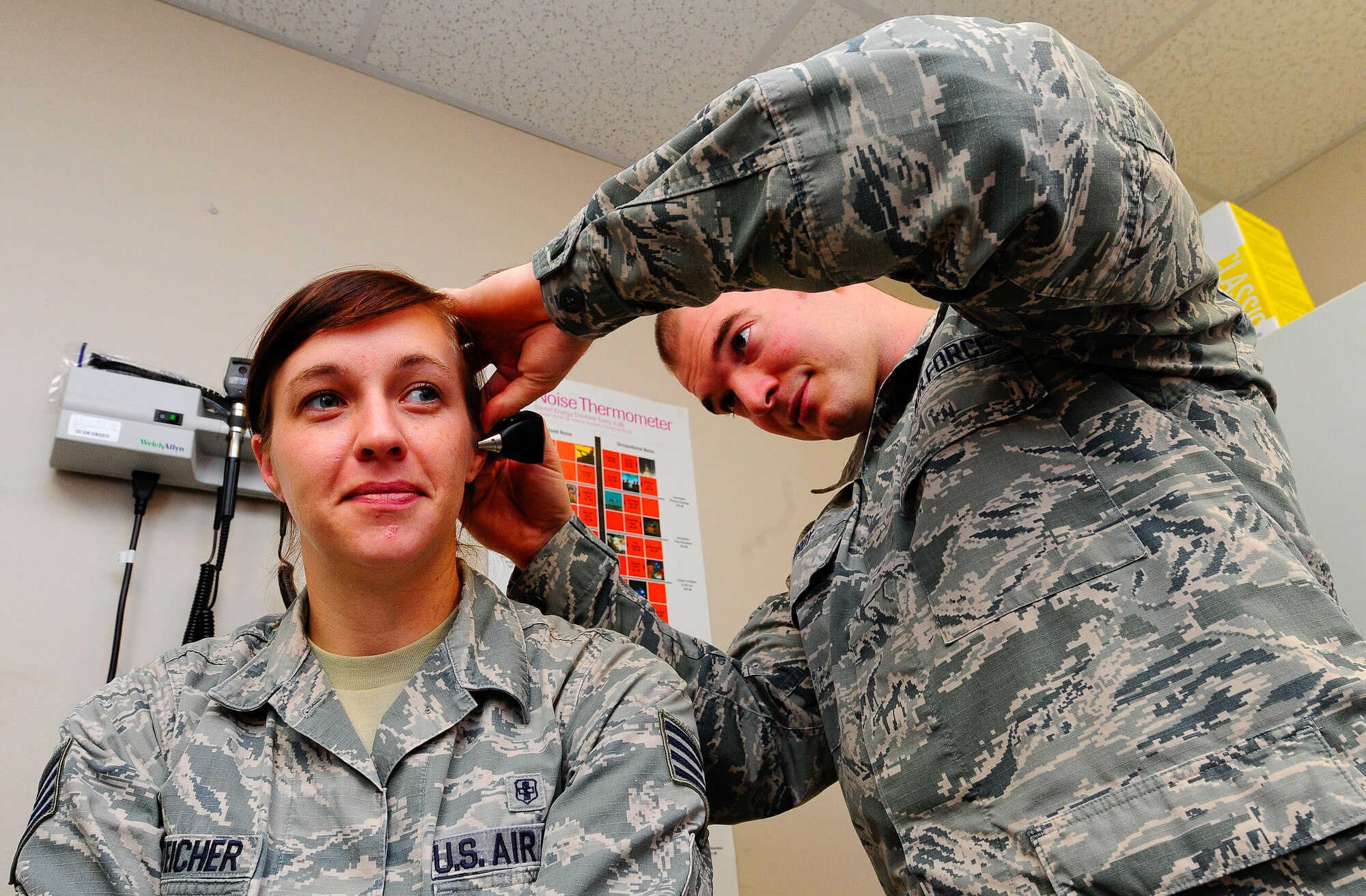 Senior Airman Jonathon Broy, 1st Special Operations Medical Operations Squadron occupational health technician, looks into 1st Special Operations Medical Squadron occupational health technician Staff Sgt. Jillian Botteicher’s ear on Hurlburt Field, Fla., Jan. 14, 2015. Broy checks patients’ ears to ensure there are no injuries to the autonomy of their ear canals. (U.S. Air Force photo/Airman 1st Class Andrea Posey)