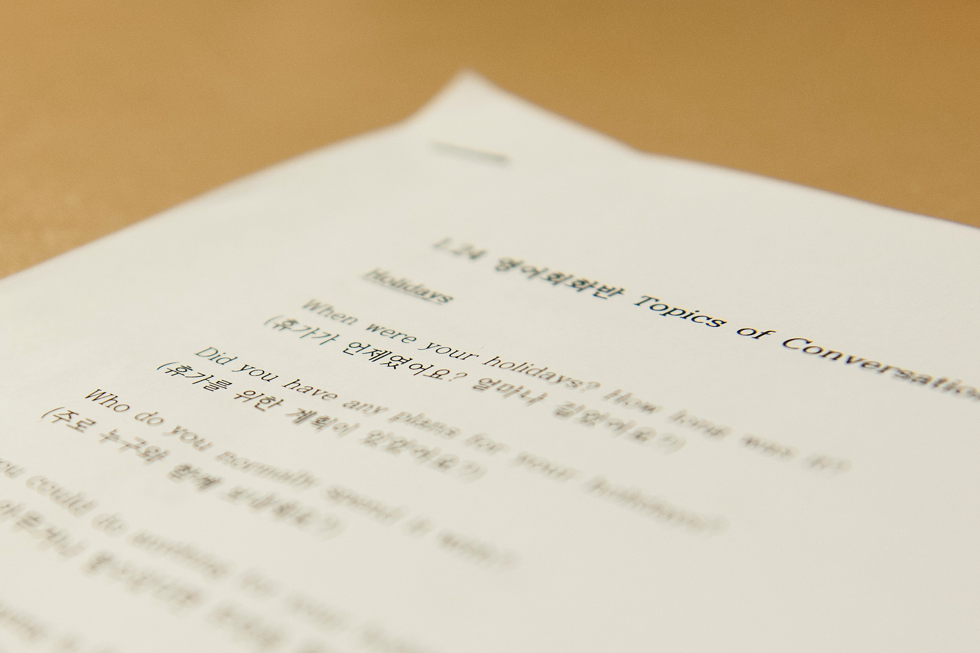 Wolf Pack and Republic of Korea Air Force members use a suggested topics of conversation guide during a ROKAF English conversational class Jan. 24, 2015, at Kunsan Air Base, ROK.  Class attendance has increased by over 300 percent since November. (U.S. Air Force photo by Senior Airman Katrina Heikkinen/Released) 