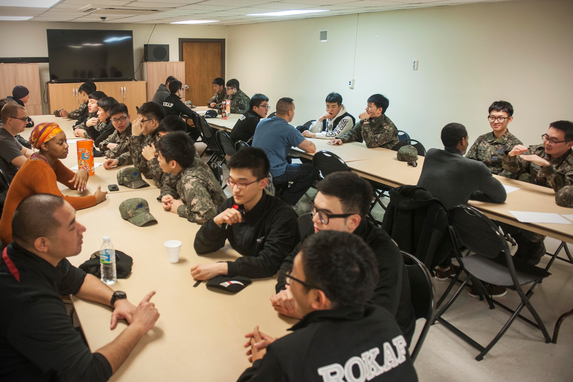 More than 20 Republic of Korea Air Force and Wolf Pack Airmen converse during a ROKAF English class at the Sonlight Inn, Jan. 24, 2014, at Kunsan Air Base, ROK. Conversational classes are held every Saturday at 1 p.m. and are open to all ranks. (U.S. Air Force photo by Senior Airman Katrina Heikkinen/Released)