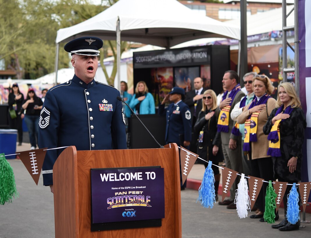 Senior Master Sgt. Ryan L. Carson, U.S. Air Force Band Max Impact vocalist, sings the National Anthem during a ribbon cutting ceremony at Fan Fest in Scottsdale, Az., Jan. 26, 2015.  The band’s mission is to honor those who have served, inspire American citizens to heighten patriotism and services, and positively impact the global community on behalf of the USAF and United States of America. (U.S. Air Force photo by/ Senior Airman Nesha Humes)