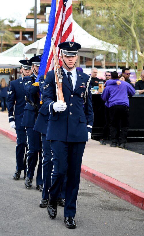 Luke Air Force Base Honor Guardsmen present the colors during the ribbon cutting ceremony at Fan Fest in Scottsdale, Az., Jan. 26, 2015.  The week-long entertainment, food and fashion event is home to Entertainment Sports and Programming Network's live broadcast for Super Bowl XLIX. (U.S. Air Force photo by/ Senior Airman Nesha Humes)