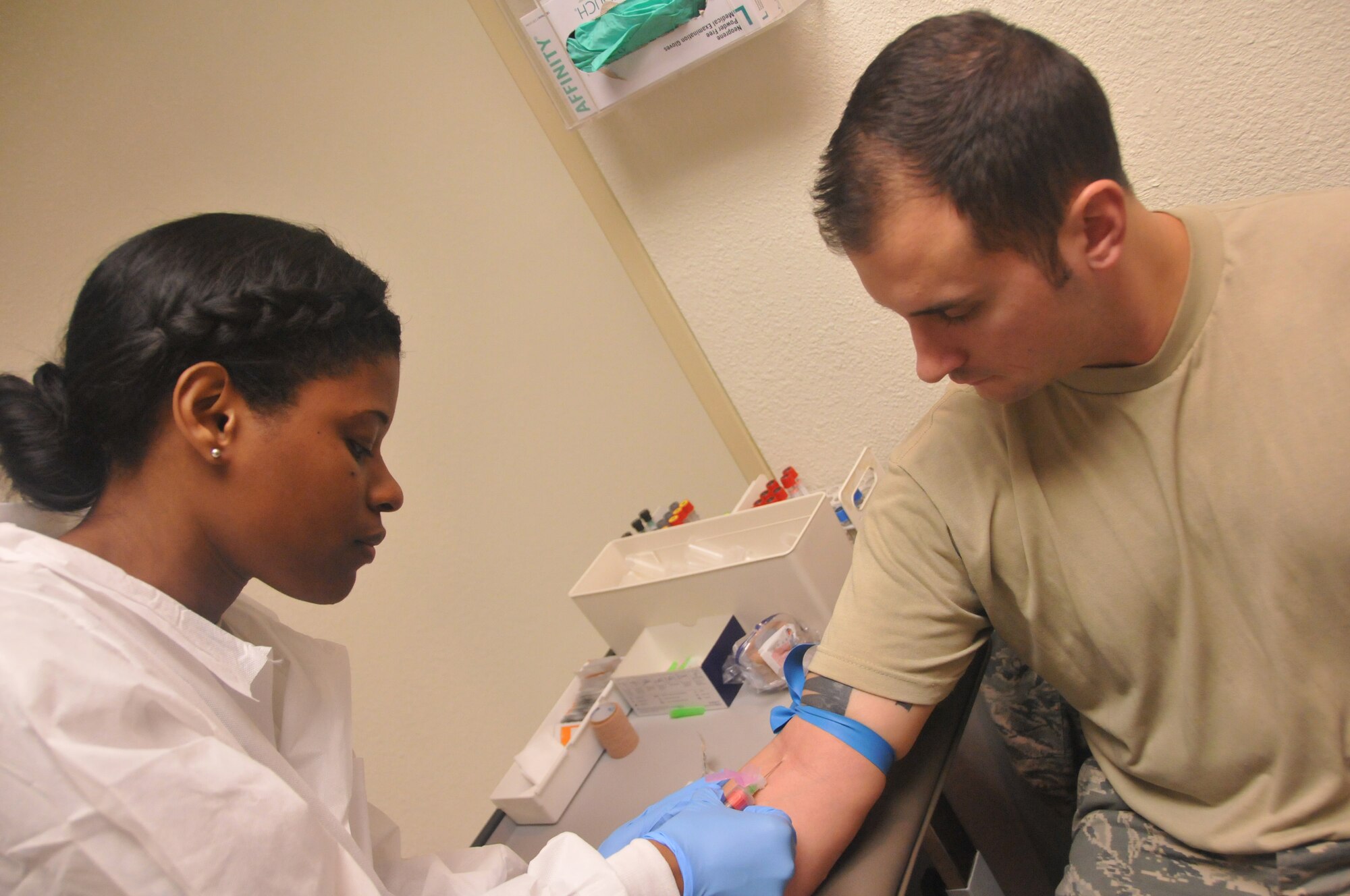 Senior Airman Ashley Thames, aero-medical technician for the 403rd Aeromedical Staging Squadron draws blood from Tech Sgt. Christopher Kantz, nondestructive inspection craftsman with the 403 Maintenance Squadron during the Unit Training Assembly Dec. 6, here. Members of the ASTS occupy the hospital during UTA weekends to provide medical services to members of the 403rd Wing. (U.S. Air Force photo/Senior Airman Nicholas Monteleone)
