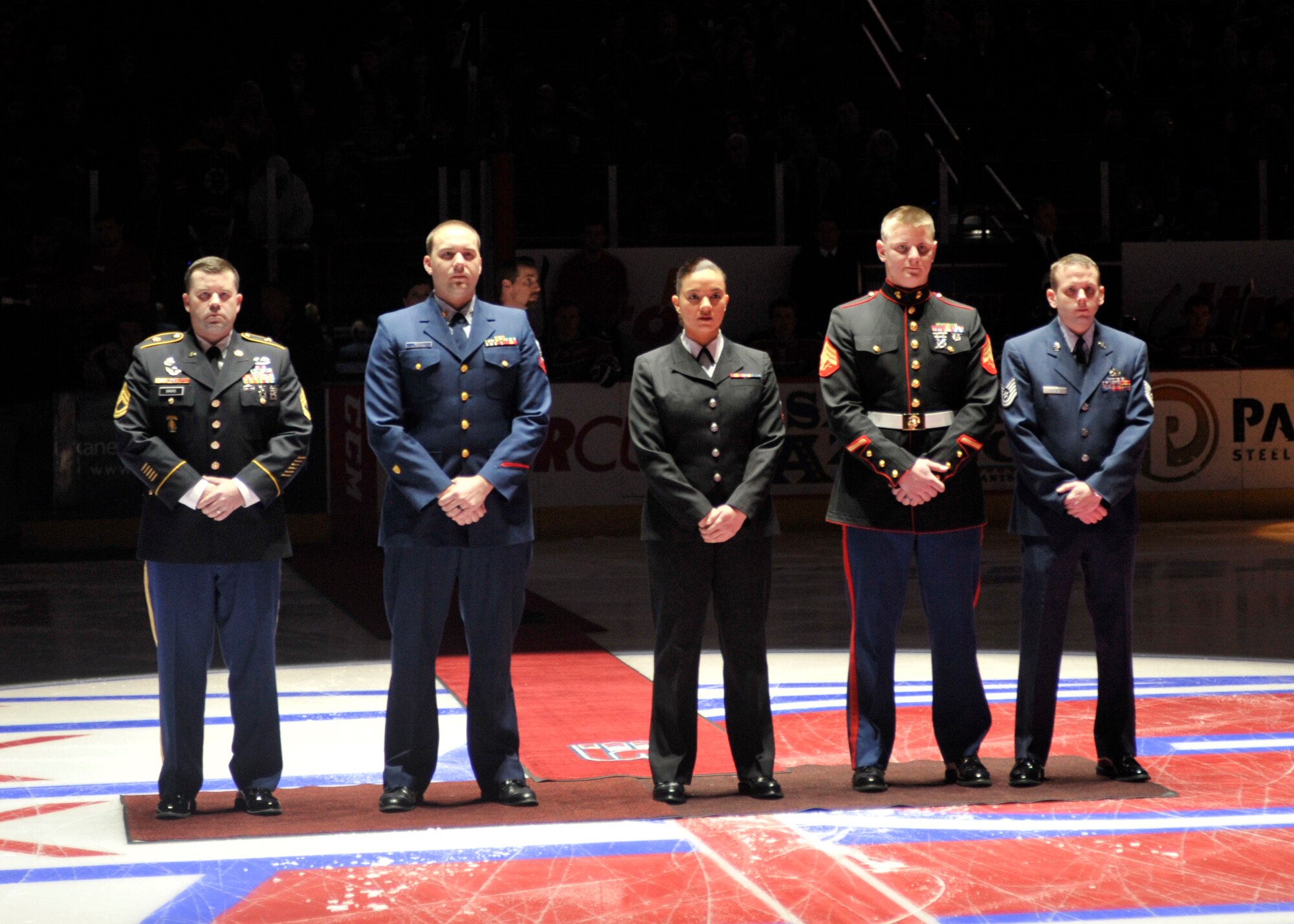 Personnel from all military branches gather at the Spokane Arena during a Spokane Chiefs hockey game Jan. 24, 2015, in Spokane Wash. The military members were selected to ceremoniously drop the puck during Military Appreciation Night. (U.S. Air Force photo/Airman 1st Class Taylor Bourgeous)     