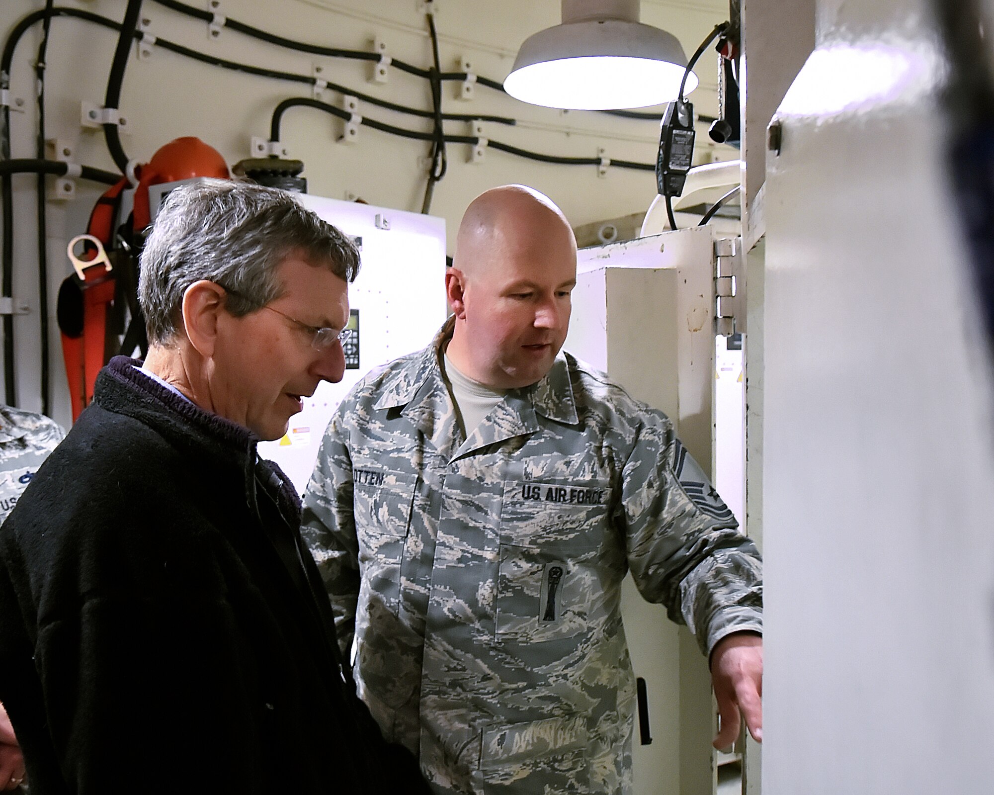 Senior Master Sgt. Brandon Otten, 90th Maintenance Operations Squadron, shows Alan Estevez, principal deputy under secretary of defense for acquisition, technology and logistics, Launch Facility Trainer Uniform-01 on F.E. Warren Air Force Base, Wyo., Jan. 14, 2015. The trainer is used to qualify missile maintainers to work on ICBMs out in the missile field. (U.S. Air Force photo/R.J. Oriez)