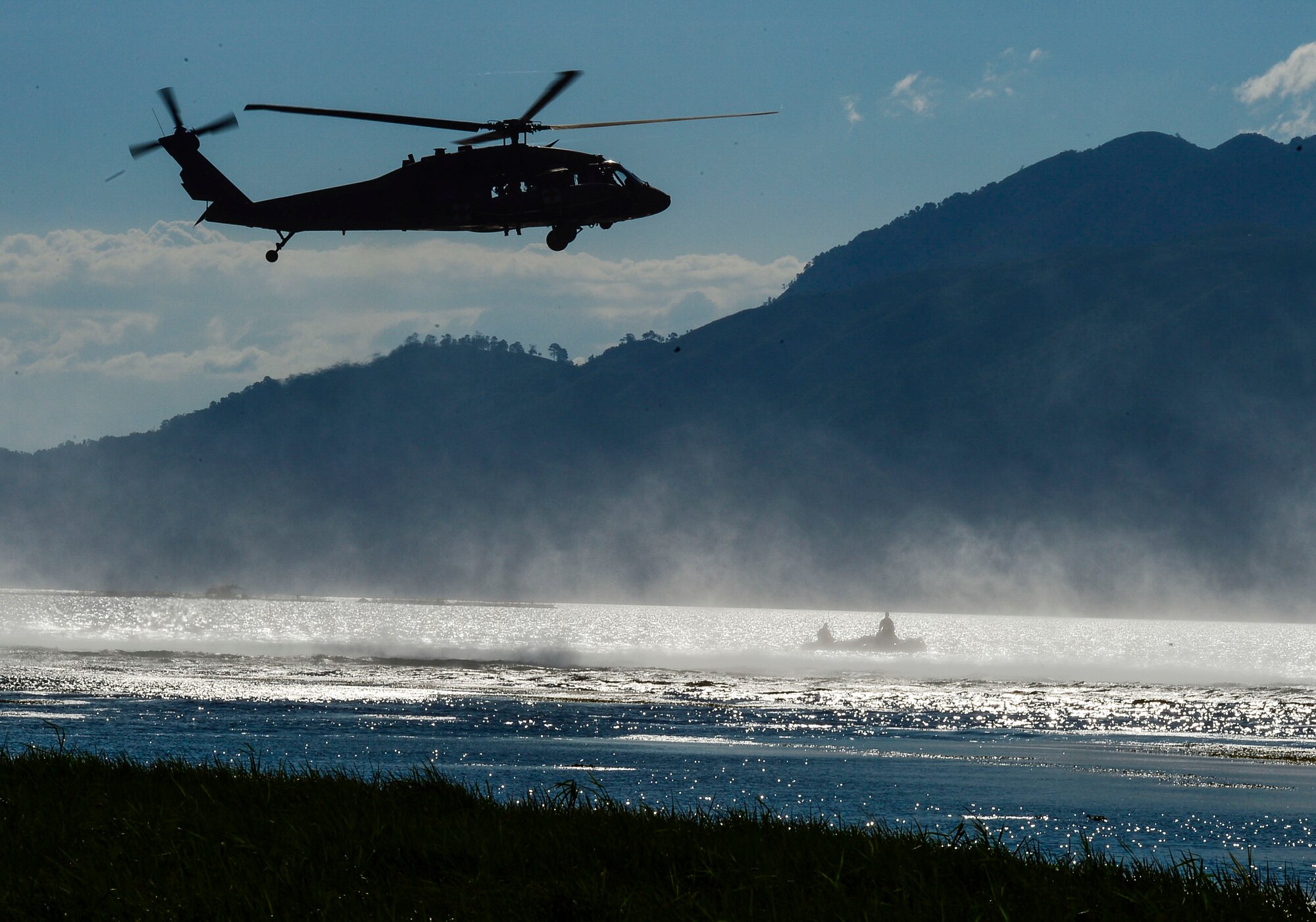 A UH-60 Black Hawk helicopter assigned to the 1-228th Aviation Regiment hovers over U.S. Army Special Operations members during over water hoist training at Lake Yojoa, Honduras, Jan. 22, 2015.   The 1-228th Aviation Regiment partnered with U.S. Army Special Operations personnel to practice recovering live personnel. The overwater hoist training was held to ensure members of Joint Task Force-Bravo are planning and preparing for crisis and contingency response, as well as countering transnational organized crime, and counterterrorism operations as part of U.S. Southern Command’s mission. Contingency planning prepares the command for various scenarios that pose the greatest probability of challenging our regional partners or threatening our national interests. (U.S. Air Force photo/Tech. Sgt. Heather Redman)