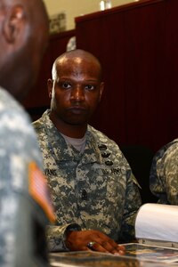 U.S. Army 1st Sgt. Ernest Evans, Bravo Company, 2nd Battalion, 210th Aviation Regiment, 128th Aviation Brigade first sergeant, listens to guidance from Sgt. Maj. James Jackson, 733rd Mission Support Group command sergeant major, during a meeting at Fort Eustis, Va., Jan. 15, 2015. Evans and other 1st Sgts. met with Jackson to discuss plans to form a “Diamond Council” to connect first sergeants on the installation, regardless of their branch of service in the U.S. Armed Forces. (U.S. Air Force photo by Senior Airman Kimberly Nagle/Released)