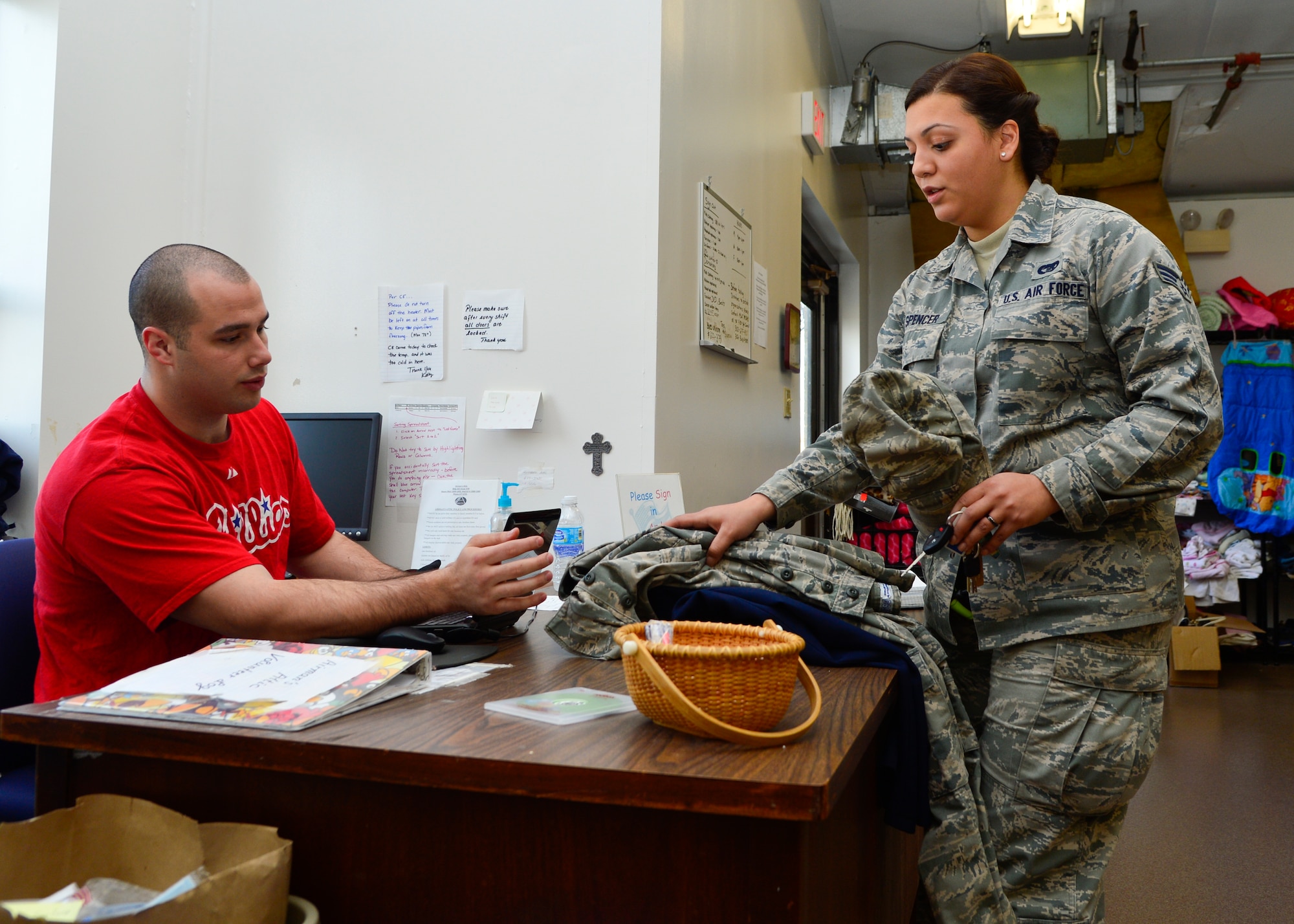 Airman 1st Class Shane Nowrey, 3d Airlift Squadron loadmaster, logs Senior Airman Vanuce Spencer, 436th Aerial Port Squadron aerial porter, taking a pair of Airman Battle Uniform trousers and dress blues bottoms Jan. 23, 2015, at the Airman’s Attic on Dover Air Force Base, Del. The Airman’s Attic features a uniform room that has ABUs, dress blues, PT gear and low quarters and boots. Airmen can get two sets of uniforms per month. (U.S. Air Force photo/Airman 1st Class William Johnson)