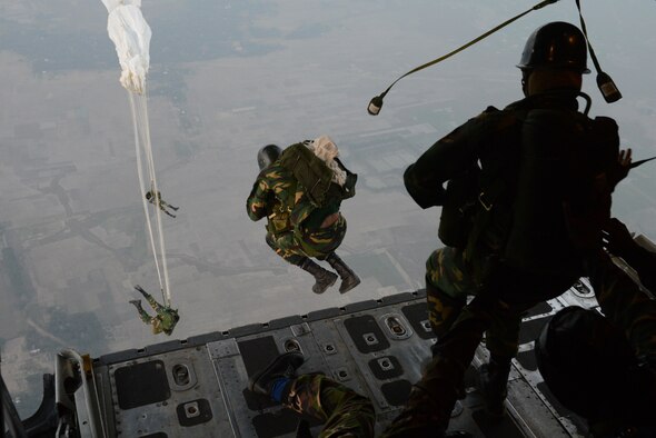 Bangladeshi commandos jump from a U.S. Air Force C-130H aircraft over a drop zone during Exercise COPE SOUTH near Sylhet, Bangladesh, Jan. 24, 2015. COPE SOUTH is a Pacific Air Forces-sponsored, bilateral tactical airlift exercise conducted in Bangladesh, with a focus on cooperative flight operations, day and night low-level navigation, tactical airdrop, and air-land missions as well as subject-matter expert exchanges in the fields of operations, maintenance and rigging disciplines. (U.S. Air Force photo by 1st Lt. Jake Bailey/Released)