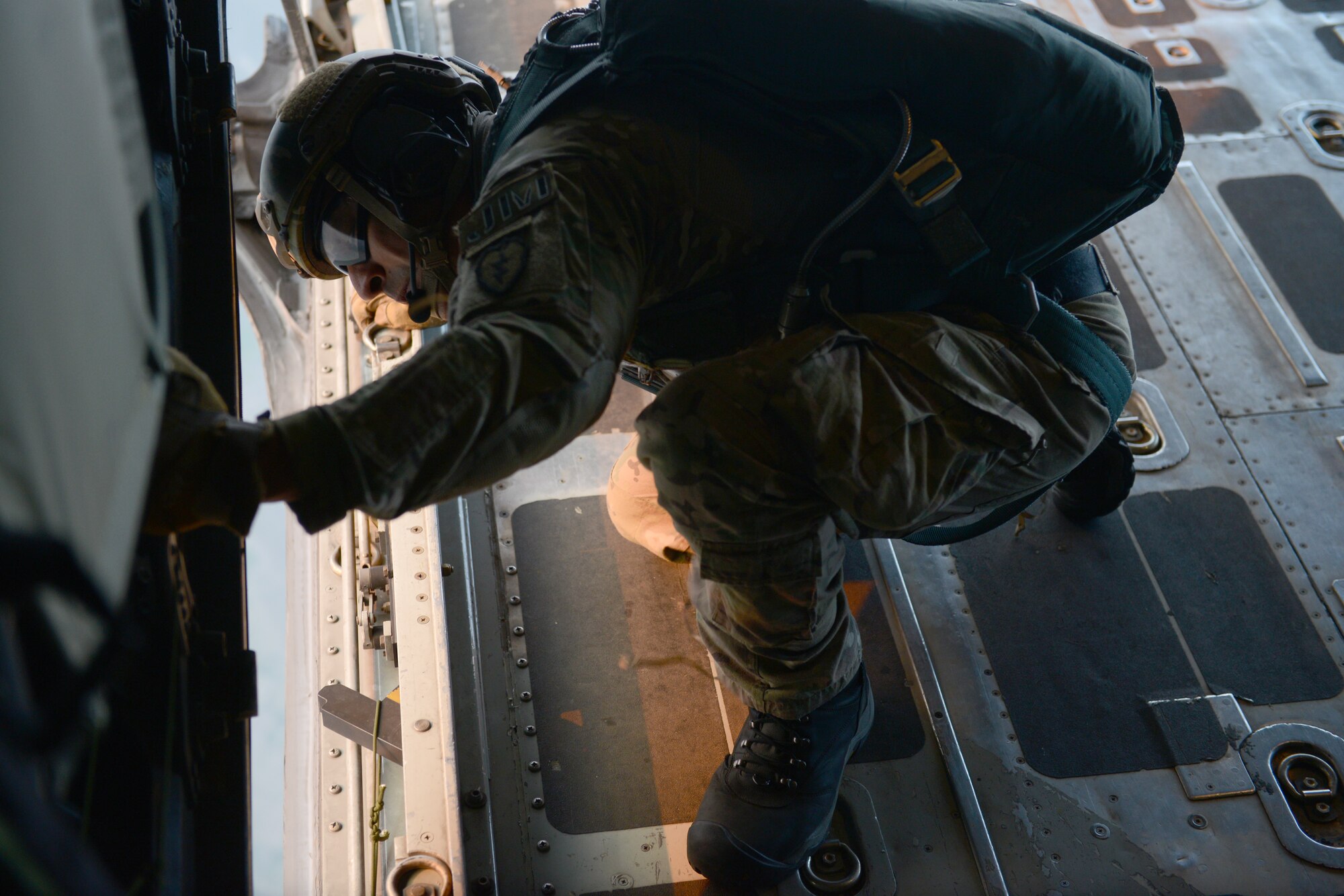 U.S. Air Force Master Sgt. Bobby Pena, a Tactical Air Control Party member assigned to the 3rd Air Support Operations Squadron, Joint Base Elmendorf Richardson, Alaska, surveys a drop zone during a personnel airdrop mission at Exercise COPE SOUTH near Sylhet, Bangladesh, Jan. 24, 2015. COPE SOUTH is a Pacific Air Forces-sponsored, bilateral tactical airlift exercise conducted in Bangladesh, with a focus on cooperative flight operations, day and night low-level navigation, tactical airdrop, and air-land missions as well as subject-matter expert exchanges in the fields of operations, maintenance and rigging disciplines. (U.S. Air Force photo by 1st Lt. Jake Bailey/Released)