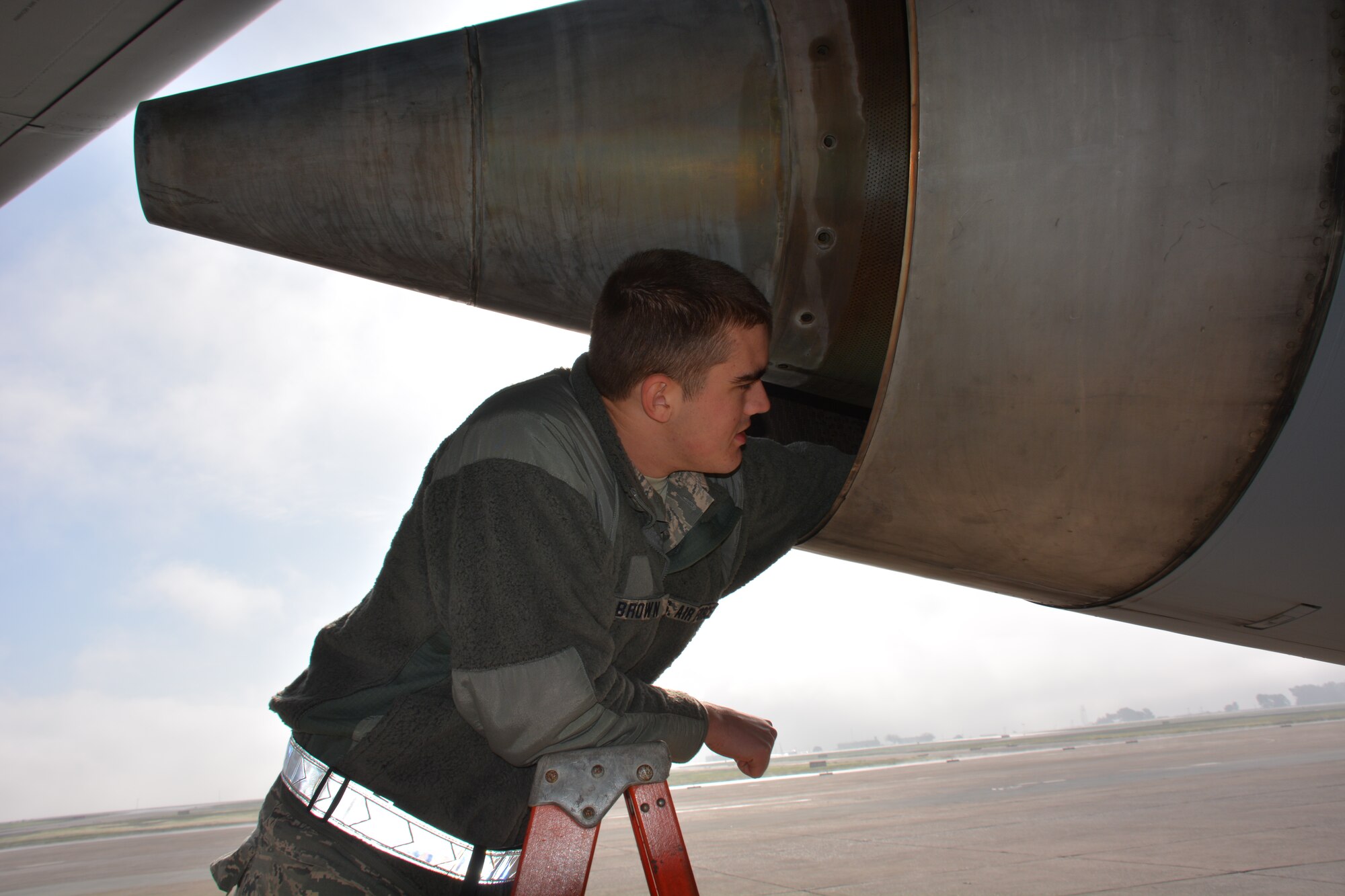 Airman Basic Joshua Brown, 373rd Training Squadron crew chief student, checks the left engine of a KC-10 Extender for foreign objects and debris Jan. 21 on the flightline at Travis Air Force Base, California. (U.S. Air Force photo/Staff Sgt. Christopher Carranza)