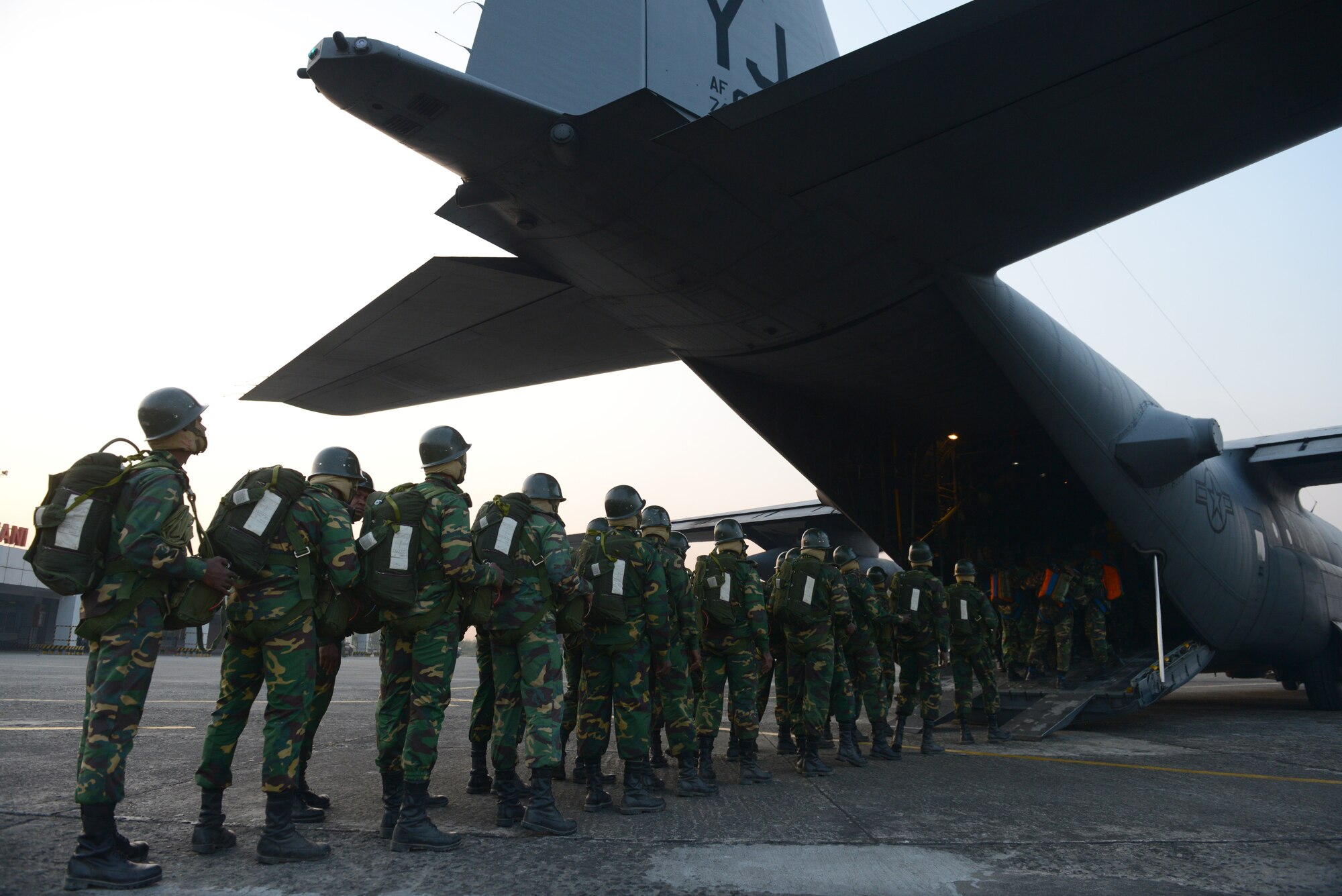 Bangladeshi commandos board a U.S. Air Force C-130H aircraft at Sylhet International Airport, Bangladesh, before conducting a personnel airdrop mission during Exercise COPE SOUTH, Jan. 24, 2015. COPE SOUTH helps cultivate common bonds, foster goodwill, and improve readiness and compatibility between members of the Bangladesh and U.S. Air Forces. (U.S. Air Force photo by 1st Lt. Jake Bailey/Released)
