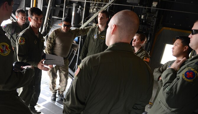 U.S. Air Force Capt. Shawn Hooton, a C-130H aircraft pilot assigned to the 36th Airlift Squadron, Yokota Air Base, Japan, briefs fellow crew members before a personal airdrop mission during Exercise COPE SOUTH at BAF Base Bangabandhu, Bangladesh, Jan. 24, 2015. COPE SOUTH helps cultivate common bonds, foster goodwill, and improve readiness and compatibility between members of the Bangladesh and U.S. Air Forces. (U.S. Air Force photo by 1st Lt. Jake Bailey/Released)