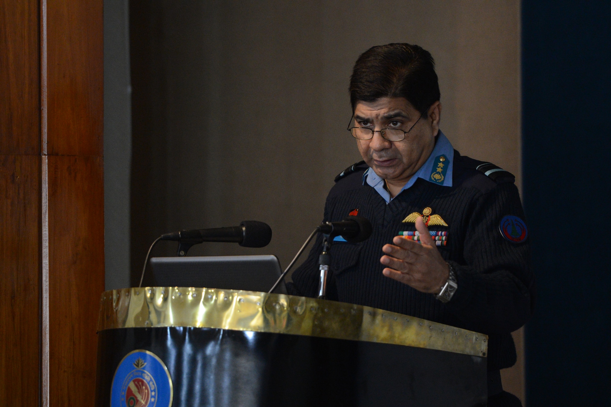 Bangladesh Air Force Air Vice Marshal M. Naim Hassan addresses an auditorium of U.S. and Bangladeshi Airmen at the opening ceremony of Exercise COPE SOUTH at BAF Base Bangabandhu, Bangladesh, Jan. 24, 2015. Hassan noted the close friendship that COPE SOUTH fosters between the two forces. (U.S. Air Force photo by 1st Lt. Jake Bailey/Released)