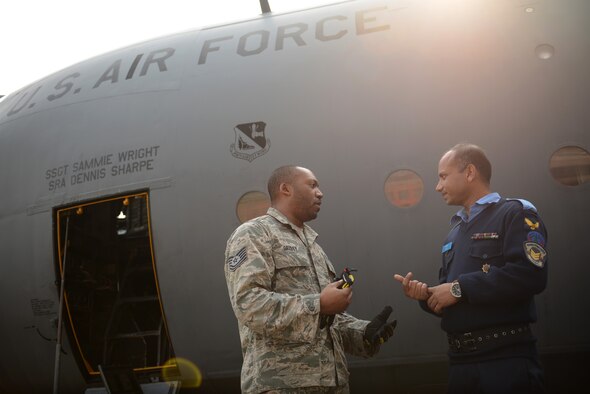 Bangladesh air force Sgt. Jamil Ashraf, right, and U.S. Air Force Tech. Sgt. Reginald Grisby discuss C-130 maintenance commonalities during Exercise COPE SOUTH 15 at BAF Base Bangabandhu, Bangladesh, Jan. 23, 2015. Ashram is a C-130B aircraft systems maintainer and Grisby is a C-130H crew chief assigned to the 374th Aircraft Maintenance Squadron at Yokota Air Base, Japan. COPE SOUTH is a Pacific Air Forces-sponsored, bilateral tactical airlift exercise conducted in Bangladesh, with a focus on cooperative flight operations, day and night low-level navigation, tactical airdrop, and air-land missions as well as subject-matter expert exchanges in the fields of operations, maintenance and rigging disciplines. (U.S. Air Force photo by 1st Lt. Jake Bailey/Released)
