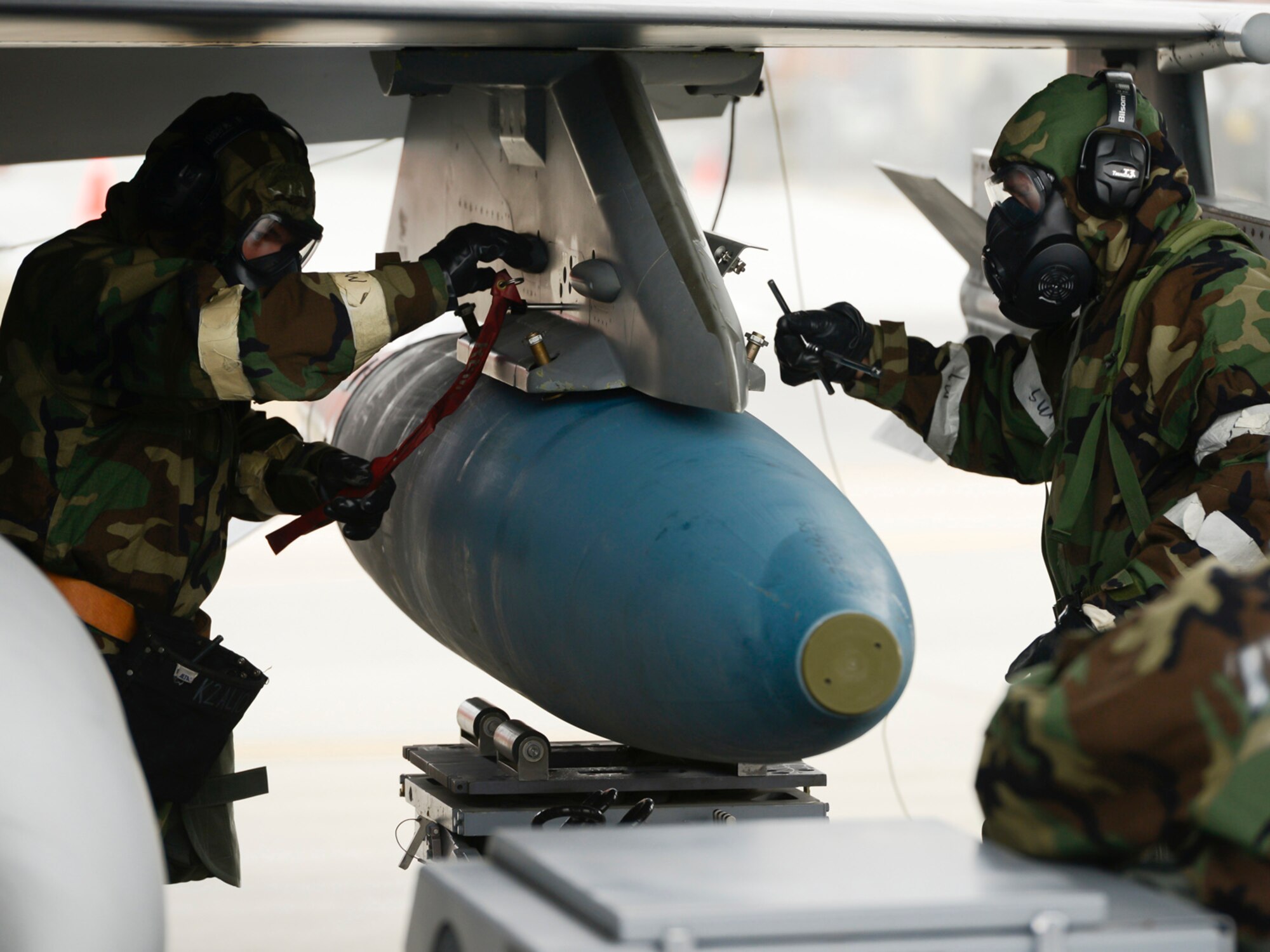 Weapon loaders, assigned to the 138th Maintenance Group, practice loading training munitions onto an F-16 during an operational readiness exercise (ORE) held, Jan. 10, 2015, at the Tulsa Air National Guard Base, Okla. The 138th Fighter Wing conducted the ORE to assess the 138th Fighter Wing's ability to accomplish design operational capability tasking in a contested, degraded operational environment utilizing ability to survive and operate principles.  (U.S. National Guard photo by Master Sgt.  Mark A. Moore/Released)