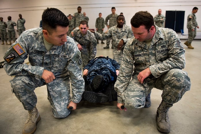 Service members assigned to Joint Base Charleston are taught the basics of carrying a patient on a litter Jan. 22, 2015, at Joint Base Charleston, S.C., during a joint service Combat Lifesaver Course hosted by Soldiers from Fort Jackson, S.C. Forty-three students participated in the course, which is designed to teach lifesaving skills to non-medical military personnel. The course is 40 hours long and incorporates classroom and practical training. (U.S. Air Force photo/Senior Airman Jared Trimarchi) 