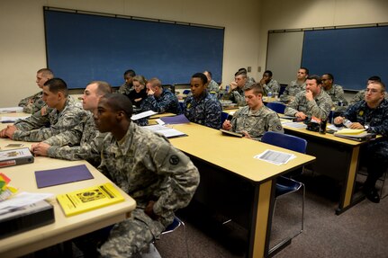 Soldiers, Sailors and Airmen take notes on litter procedures Jan. 22, 2015, at Joint Base Charleston, S.C., during a joint service Combat Lifesaver Course.  The event was hosted by Soldiers stationed at Fort Jackson, S.C. Forty-three students participated in the course, which is designed to teach lifesaving skills to non-medical military personnel. The course is 40 hours long and incorporates classroom and practical training. (U.S. Air Force photo/Senior Airman Jared Trimarchi) 