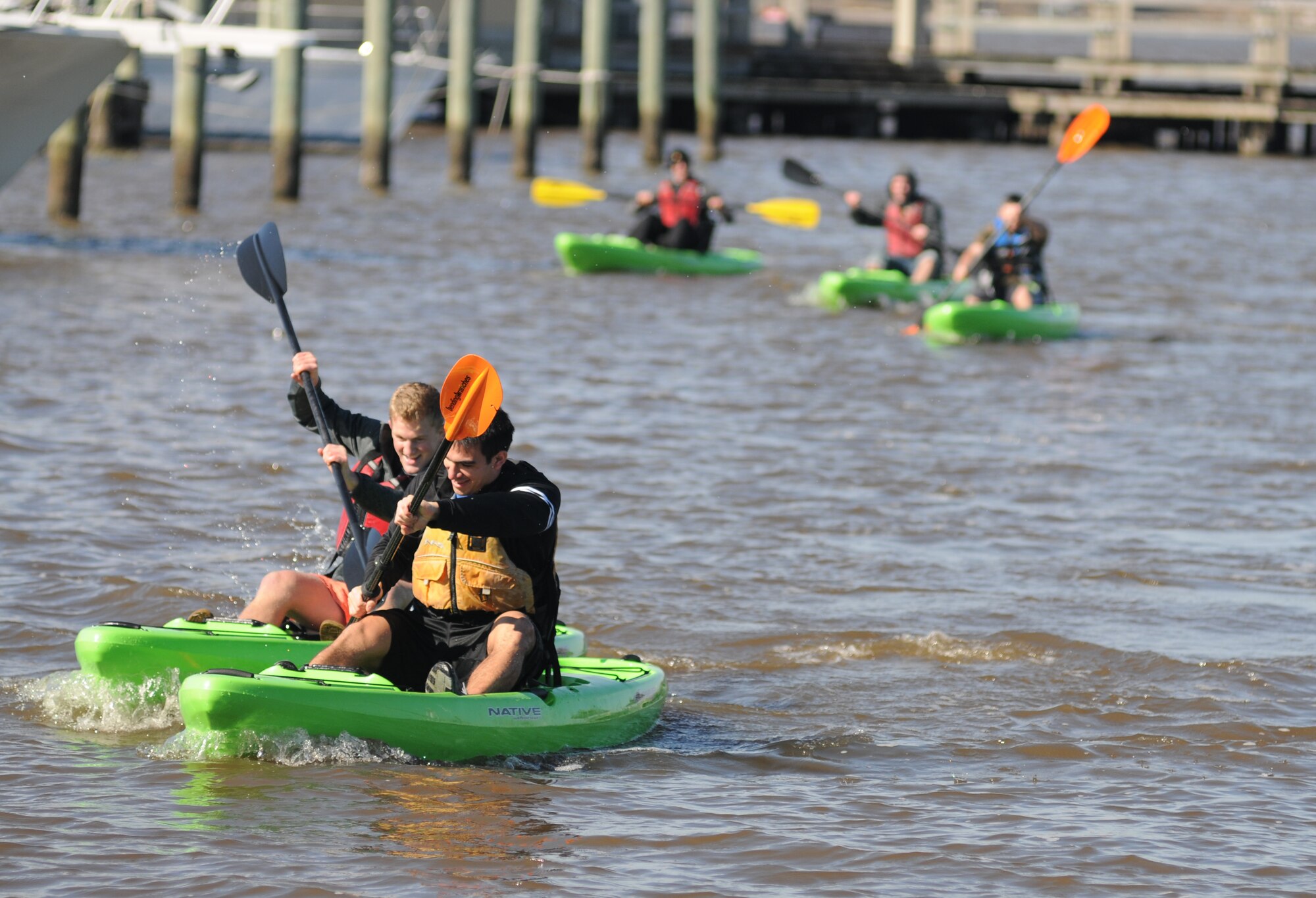 Second Lts. Micah Villarreal and Daniel Baucke, 333rd Training Squadron cyber warfare operations students, paddle their way to the finish line in the kayak races during the third annual Polar Bear Regatta Jan. 24, 2015, at marina park, Keesler Air Force Base, Miss.  The event was sponsored by outdoor recreation. (U.S. Air Force photo by Kemberly Groue)