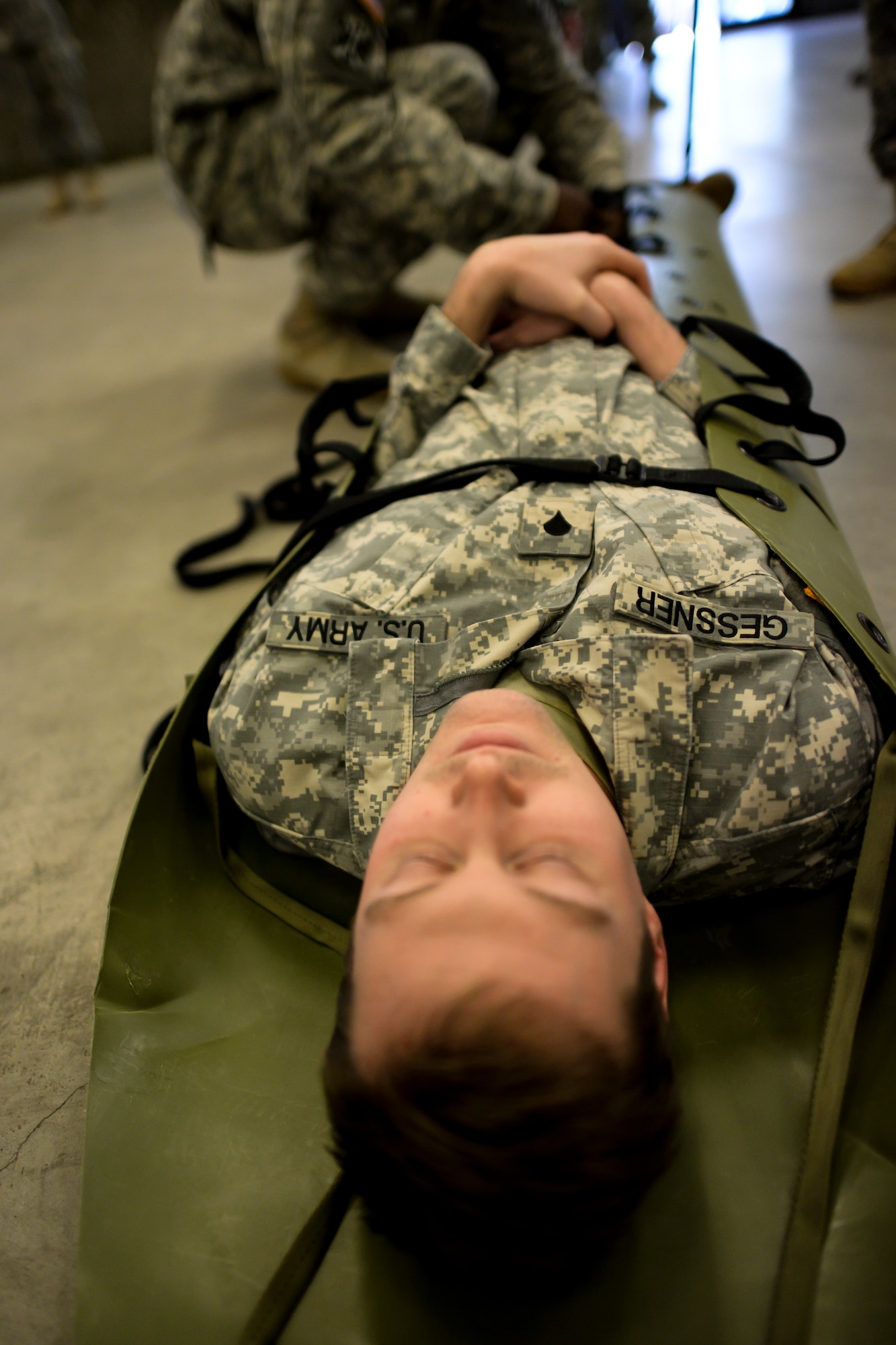 Specialist Peter Gessner, a Soldier from the 941st Transportation Company, is strapped securely onto a litter  Jan. 22, 2015, at Joint Base Charleston, S.C., during a joint service Combat Lifesaver Course. The event was hosted by Soldiers stationed at Fort Jackson, S.C. Forty-three students participated in the course which is designed to teach lifesaving skills to non-medical military personnel. The course is 40 hours long and incorporates classroom and practical training. (U.S. Air Force photo/Senior Airman Jared Trimarchi) 