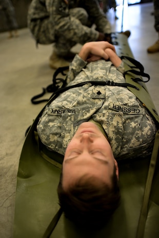 Specialist Peter Gessner, a Soldier from the 941st Transportation Company, is strapped securely onto a litter  Jan. 22, 2015, at Joint Base Charleston, S.C., during a joint service Combat Lifesaver Course. The event was hosted by Soldiers stationed at Fort Jackson, S.C. Forty-three students participated in the course which is designed to teach lifesaving skills to non-medical military personnel. The course is 40 hours long and incorporates classroom and practical training. (U.S. Air Force photo/Senior Airman Jared Trimarchi) 