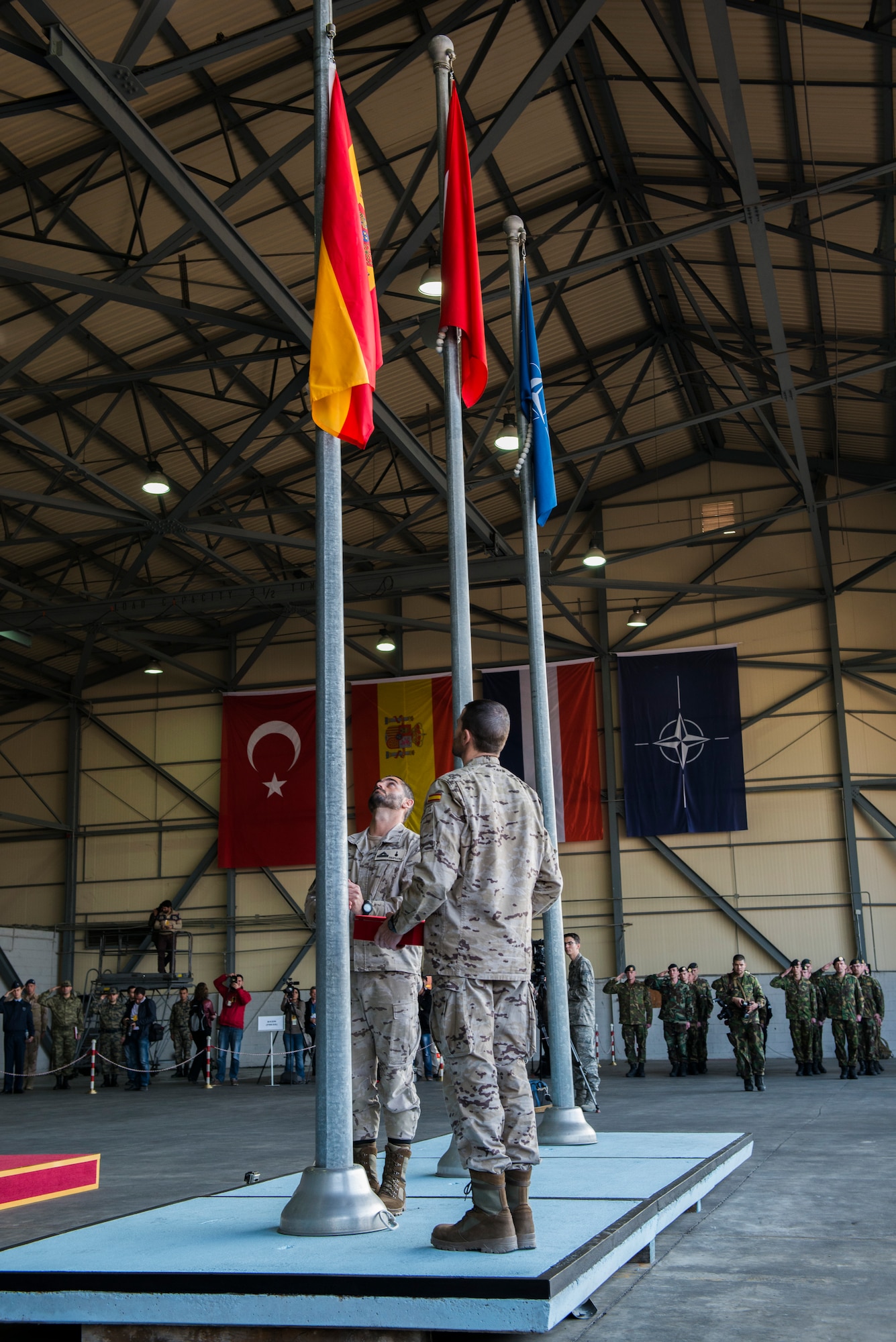 Spanish forces raise their flag during a change of responsibility ceremony Jan. 26, 2015, at Incirlik Air Base, Turkey. The raising of the flag is a symbol of Spain’s presence and support of Operation Active Fence. (U.S. Air Force photo by Airman Cory W. Bush/Released)