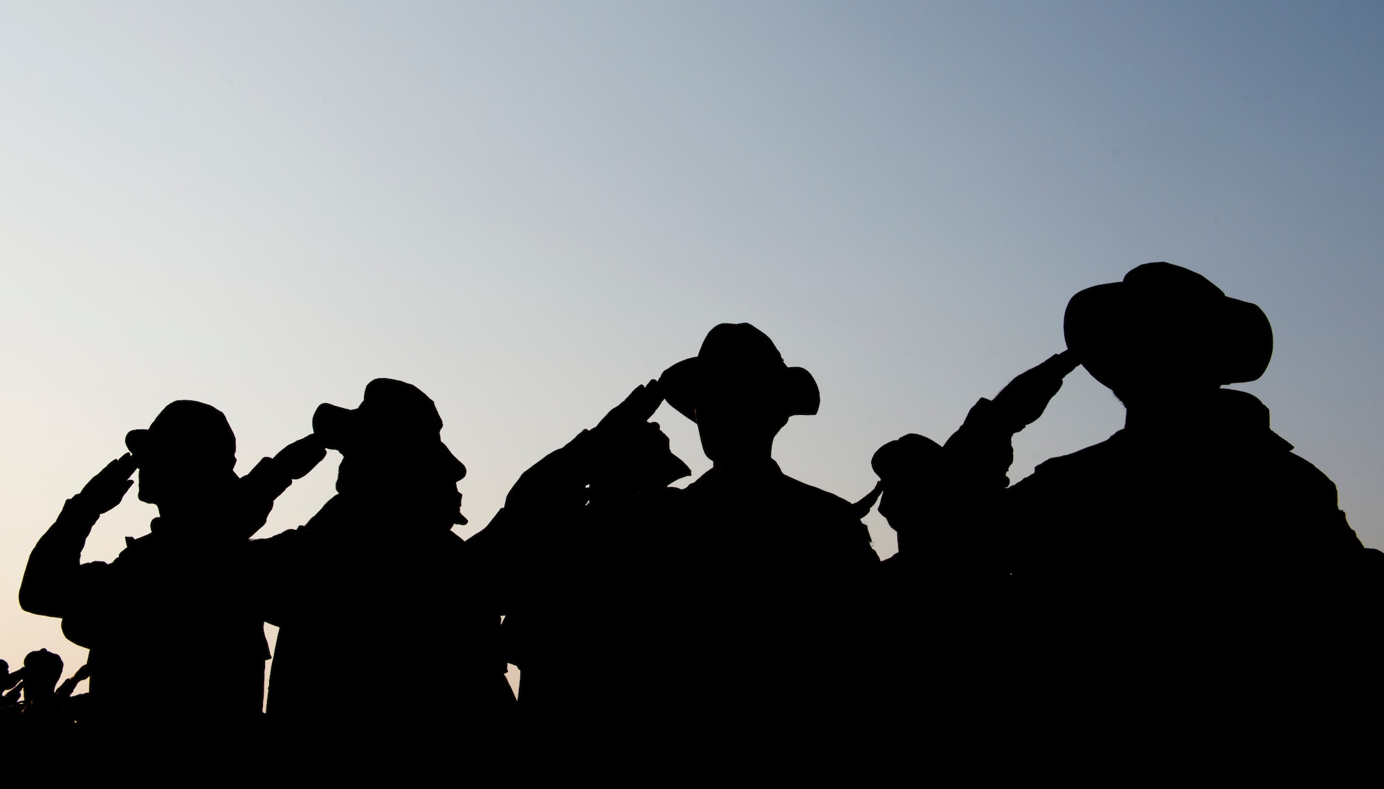 Spanish soldiers salute as the Dutch flag is lowered during a change of responsibility ceremony Jan. 26, 2015, at Incirlik Air Base, Turkey. The Dutch forces spent two years providing air defense for the city of Adana, including Incirlik Air Base. (U.S. Air Force photo by Airman Cory W. Bush/Released)