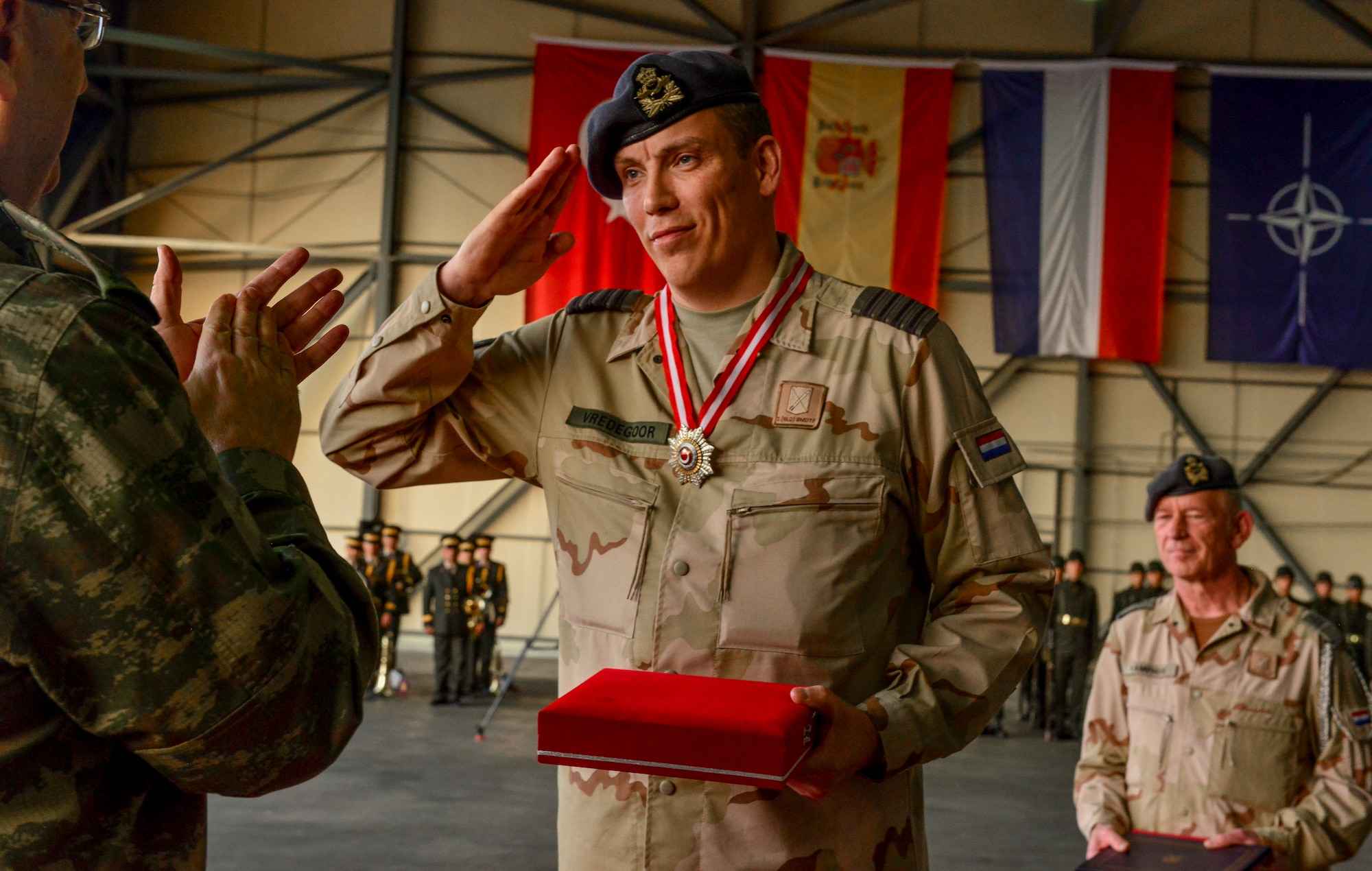 Col. Niels Vredegoor, 1st Netherlands Ballistic Missile Defense Task Force commander, salutes Gen. Adem HUDUTI, 2nd Army commander, during a change of responsibility ceremony Jan. 26, 2015, at Incirlik Air, Base Turkey. Vredegoor was awarded a Decoration of Merit for the two-year effort in continuing the North Atlantic Treaty Organization mission Operation Active Fence. (U.S. Air Force photo by Senior Airman Michael Battles/Released)