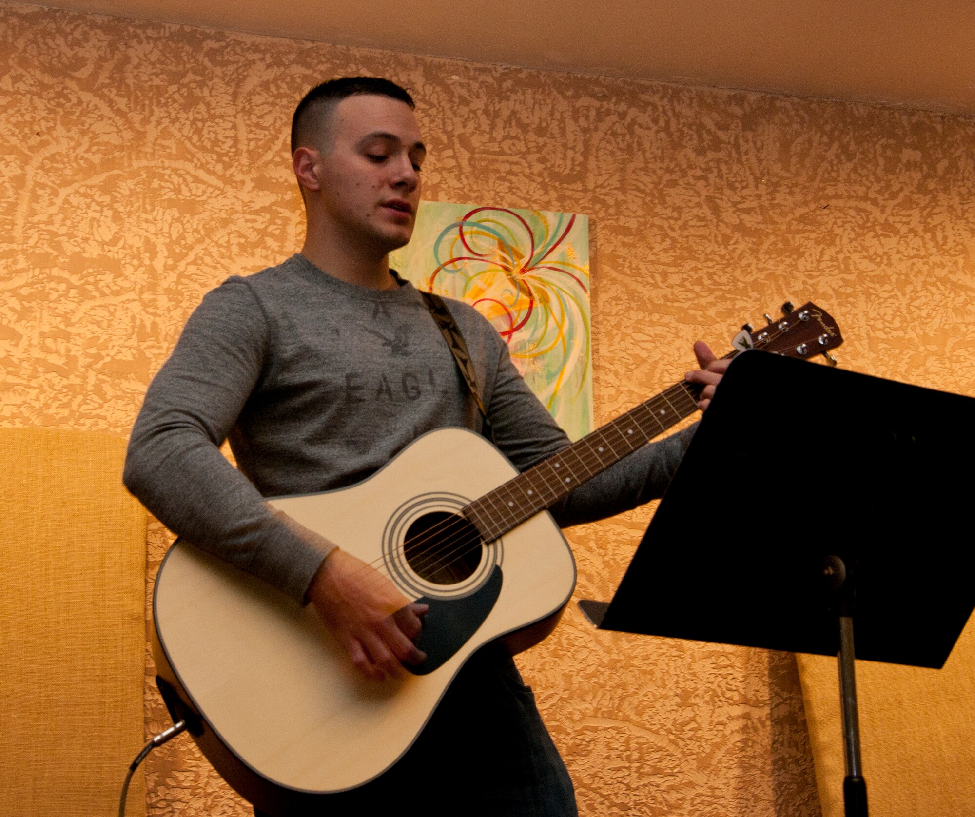 Staff Sgt. Daniel Rivera, 90th Force Support Squadron Airman Leadership School instructor at F.E. Warren Air Force Base, Wyo., plays guitar during band practice Nov. 6, 2014, in the Cheyenne Vineyard Church in Cheyenne. Rivera learned to play multiple instruments including bongos, congas, guitar and piano at a young age. (U.S. Air Force photo by Senior Airman Jason Wiese)