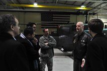Lt. Col. Chris Brady, 54th Helicopter Squadron commander, briefs distinguished visitors about the capabilities of the UH-1N Helicopter on Minot Air Force Base, N.D., Jan. 12, 2014. During the brief, the group also viewed the inside of the helicopter to understand how the pilots operate the aircraft. (U.S. Air Force photo/Senior Airman Malia Jenkins)   